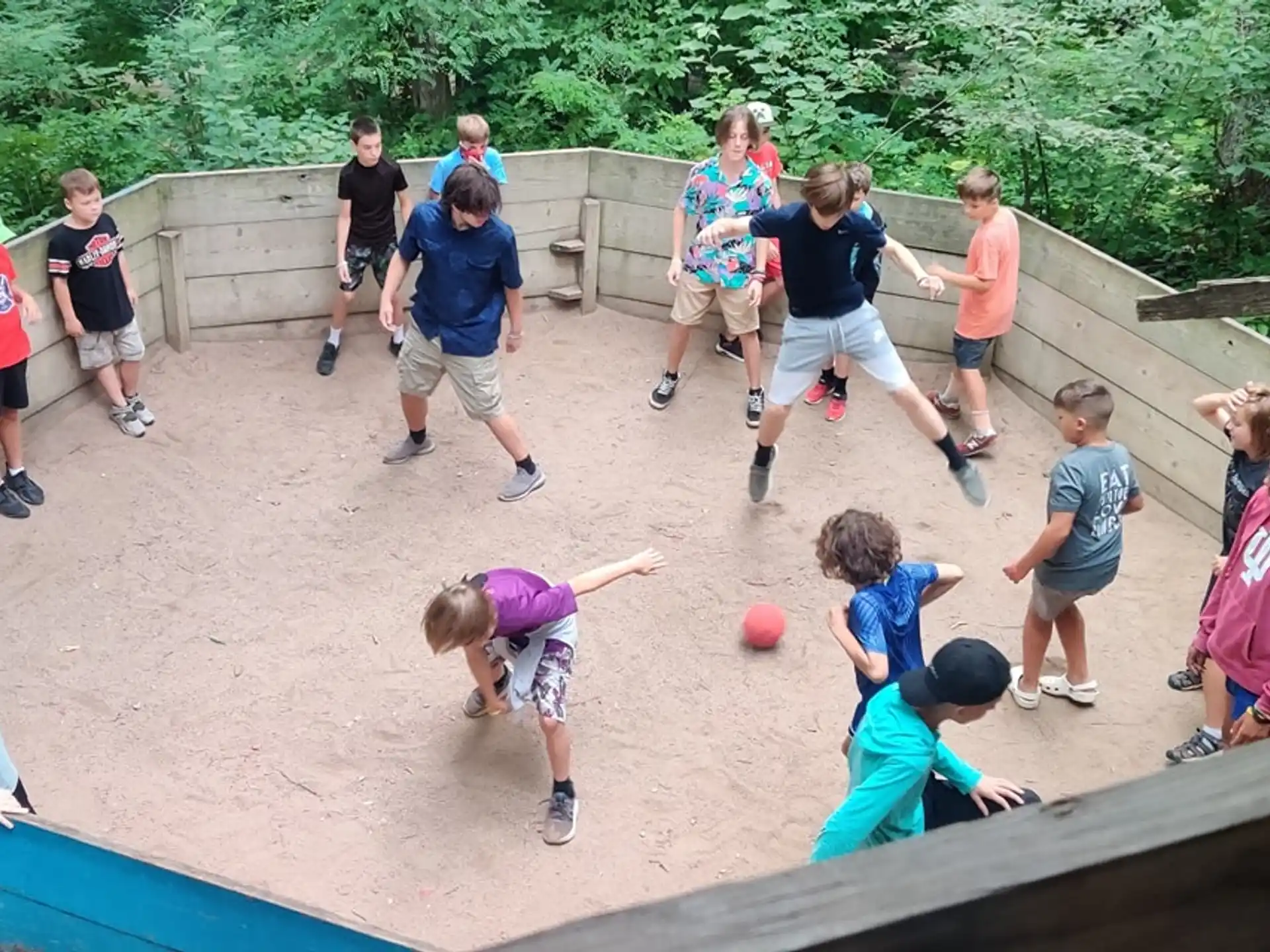 a group of people playing with a ball in a playground