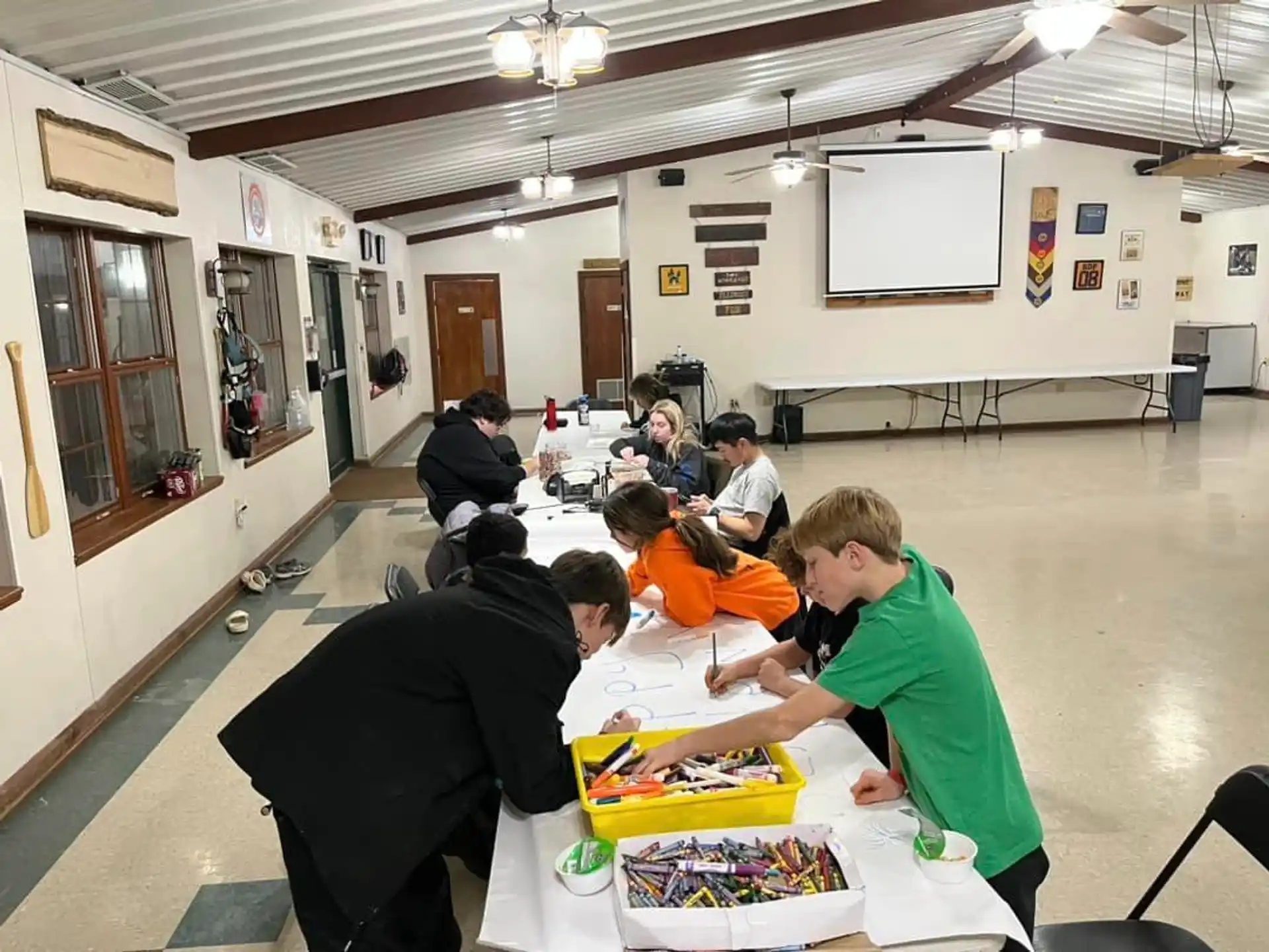 a group of people sitting at a table with food on it