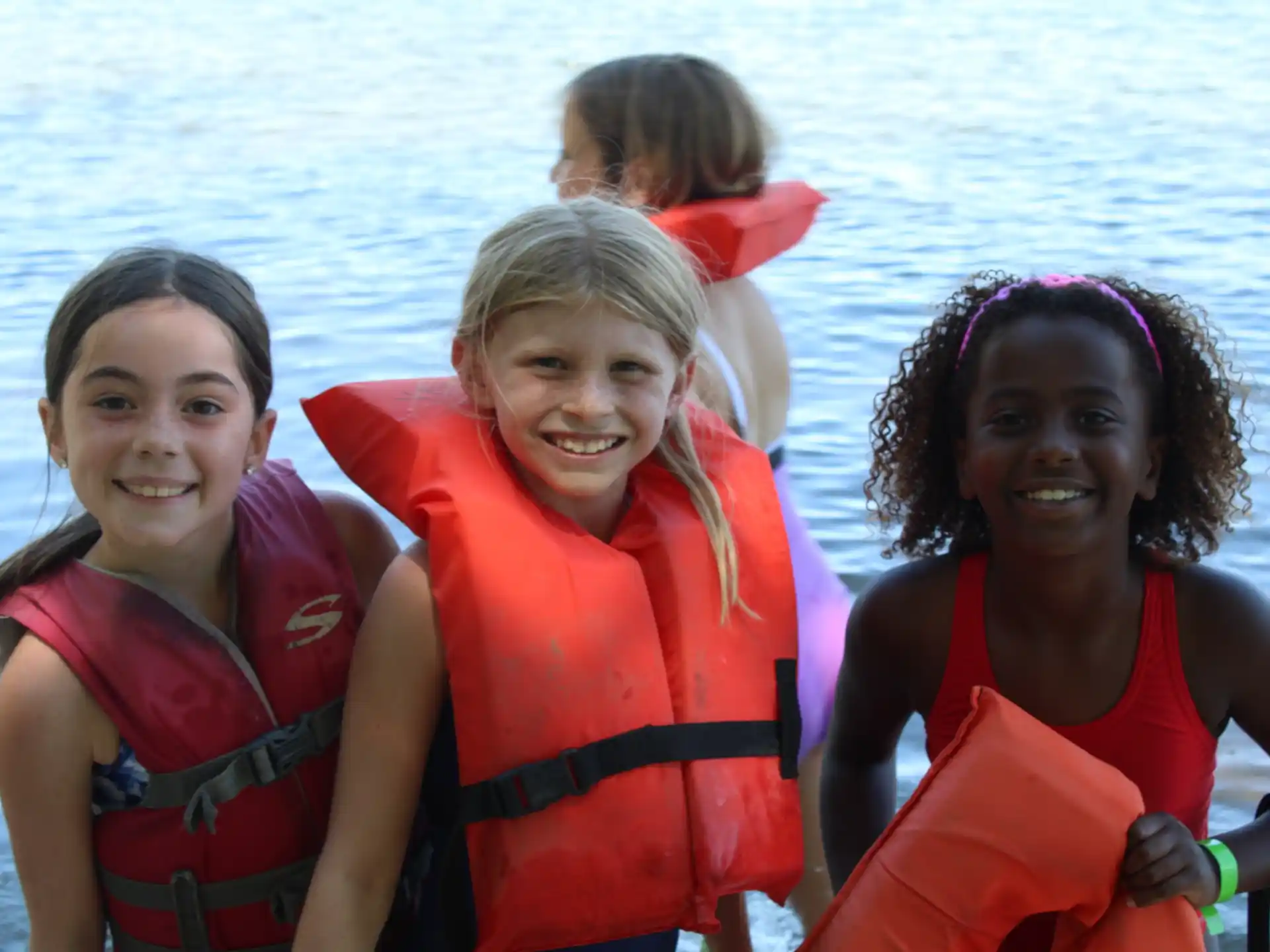 a group of girls wearing life jackets