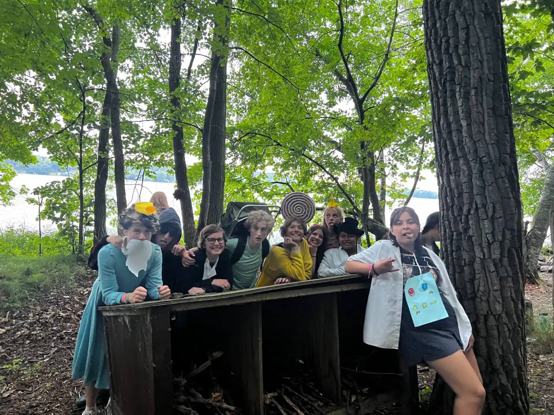 a group of people sitting at a table in a park