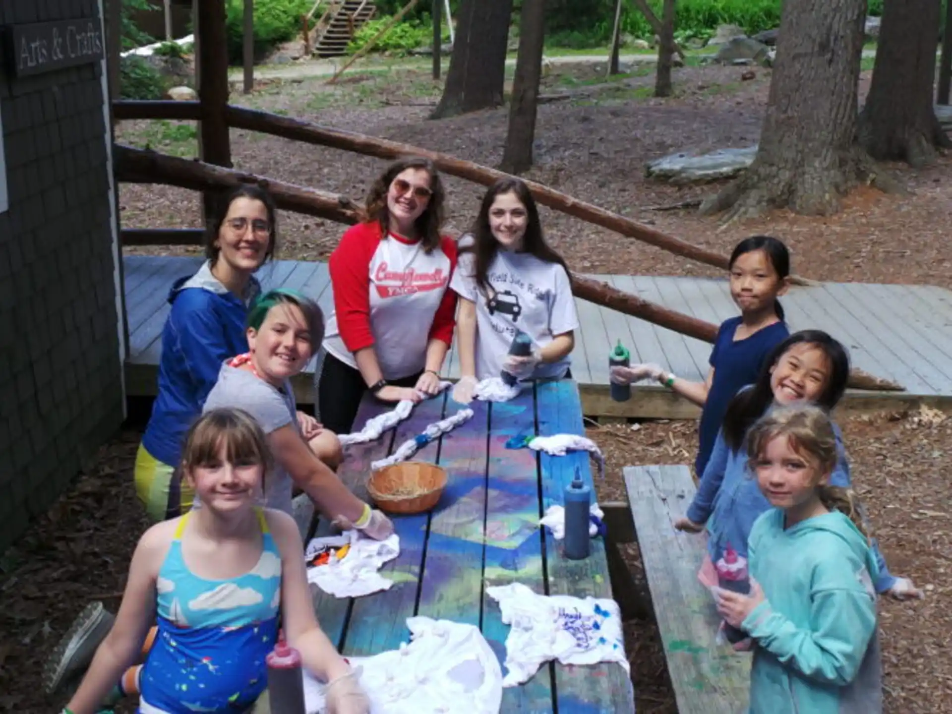 a group of people sitting around a table outside