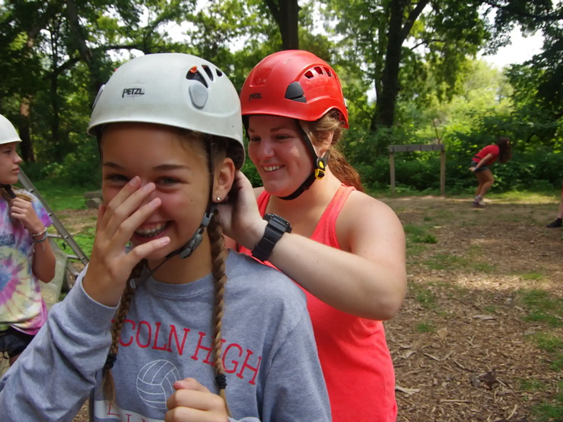 a person holding a boy in a helmet