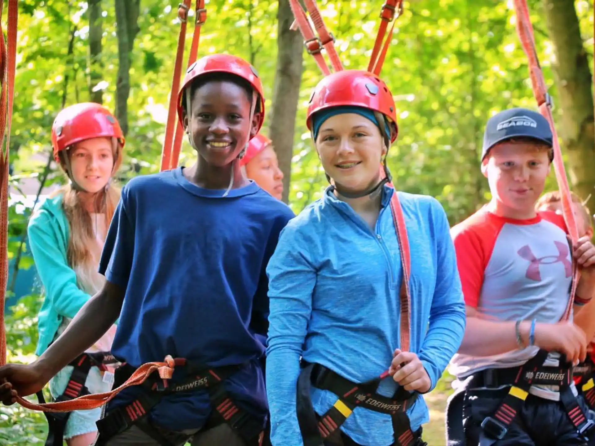 a group of people wearing helmets and harnesses
