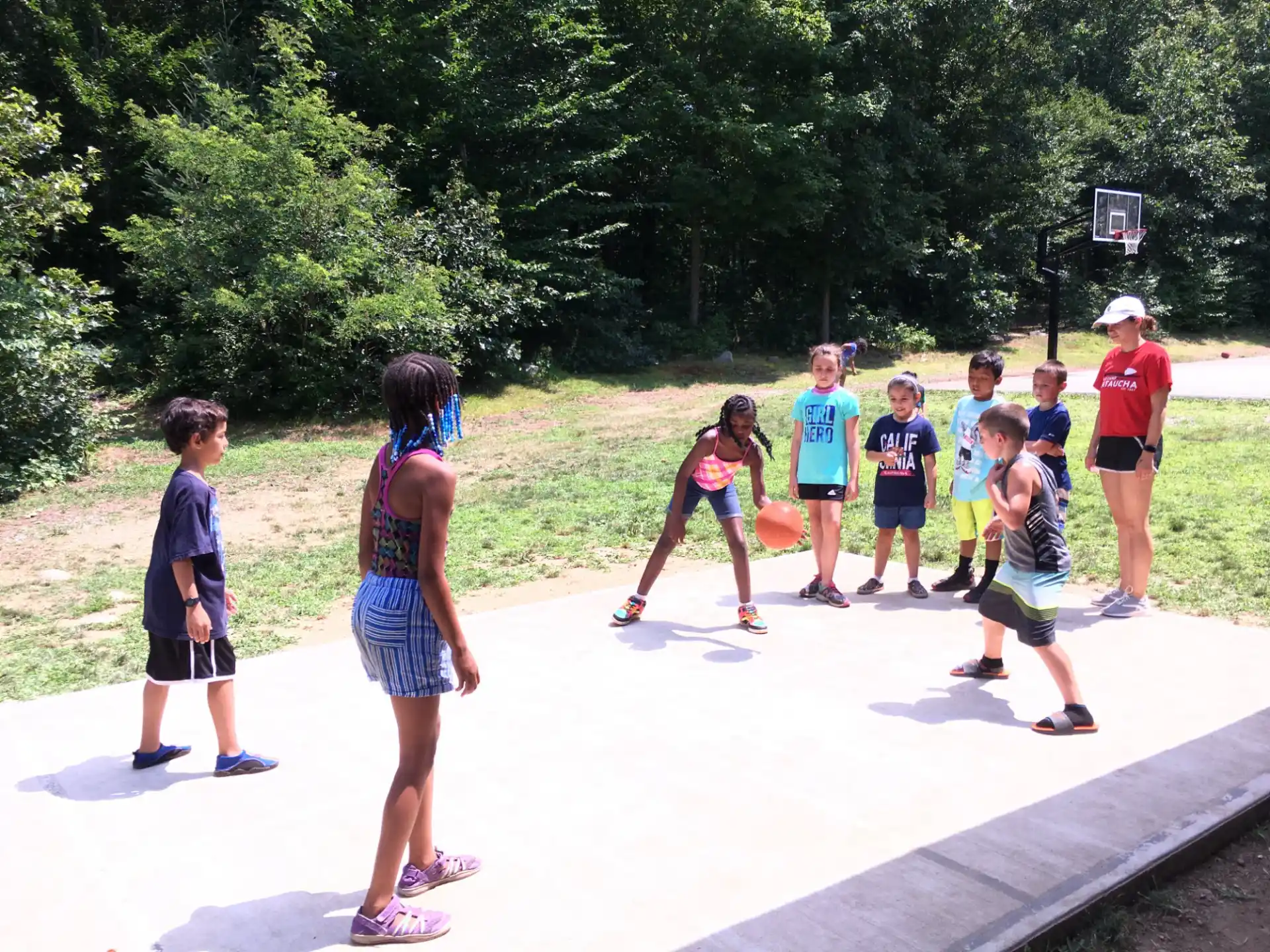 a group of people playing basketball