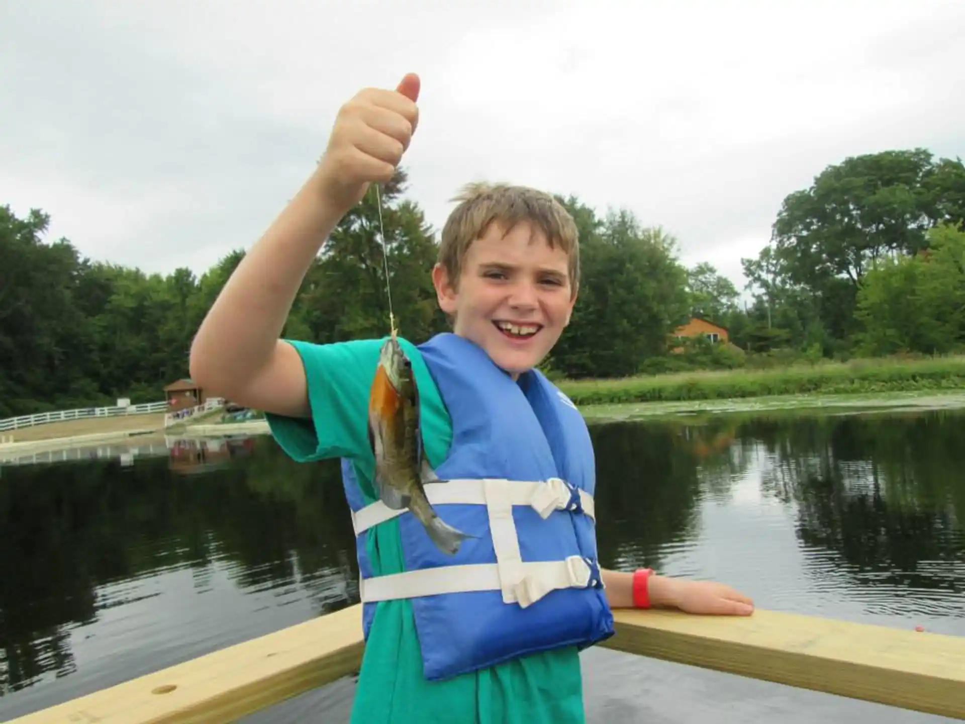 a boy holding a fish