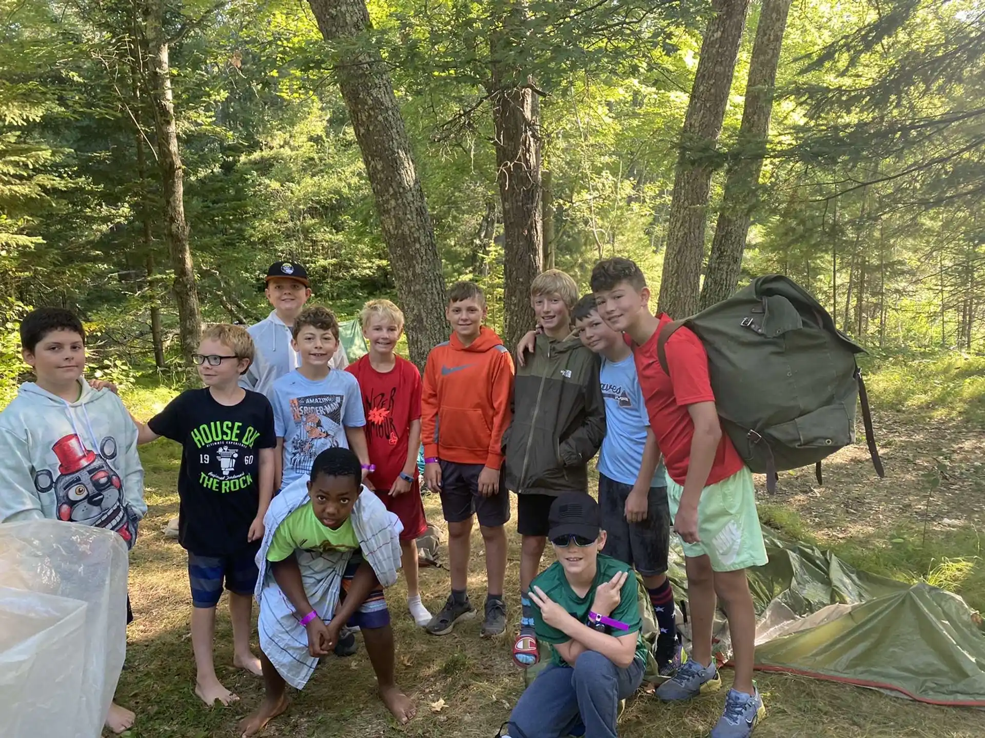 a group of people standing in a forest