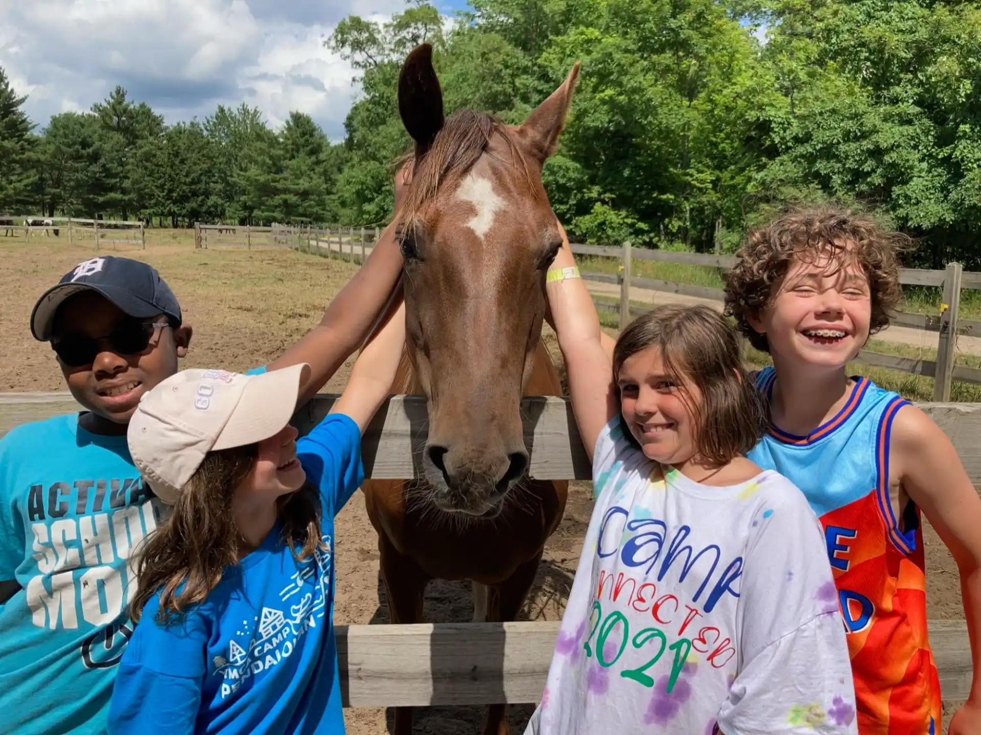 a group of people posing with a horse