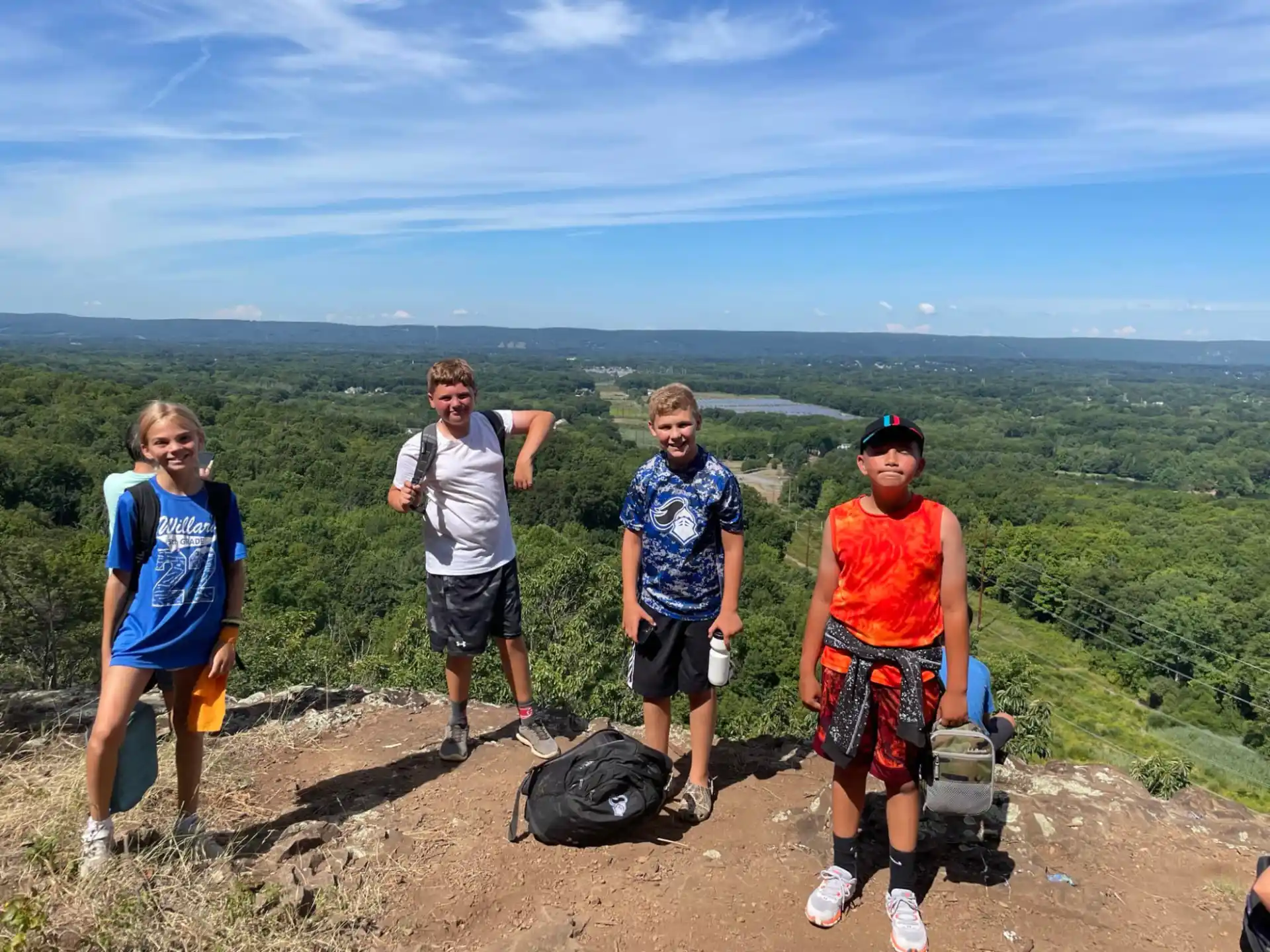 a group of people posing for a photo on a mountain