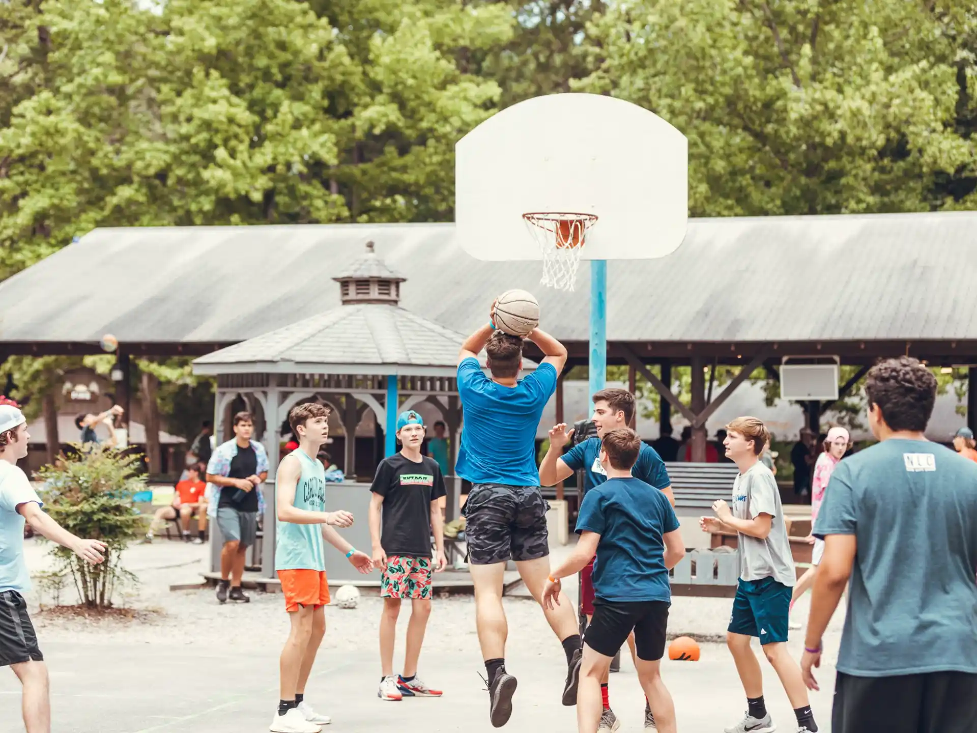 a group of people playing basketball