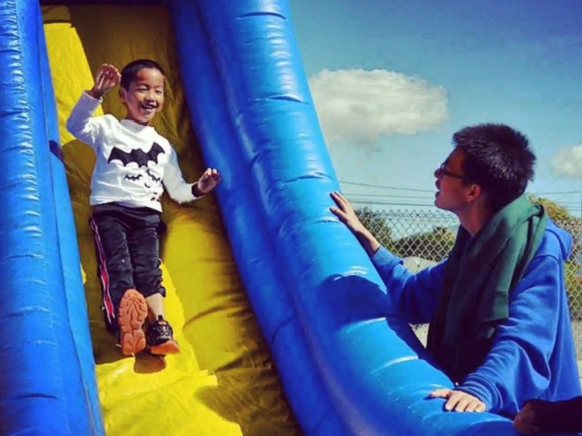 a person and a girl on a slide