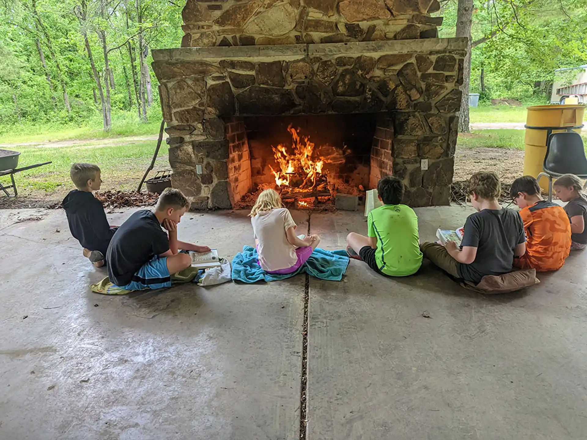 a group of people sitting around a fire pit