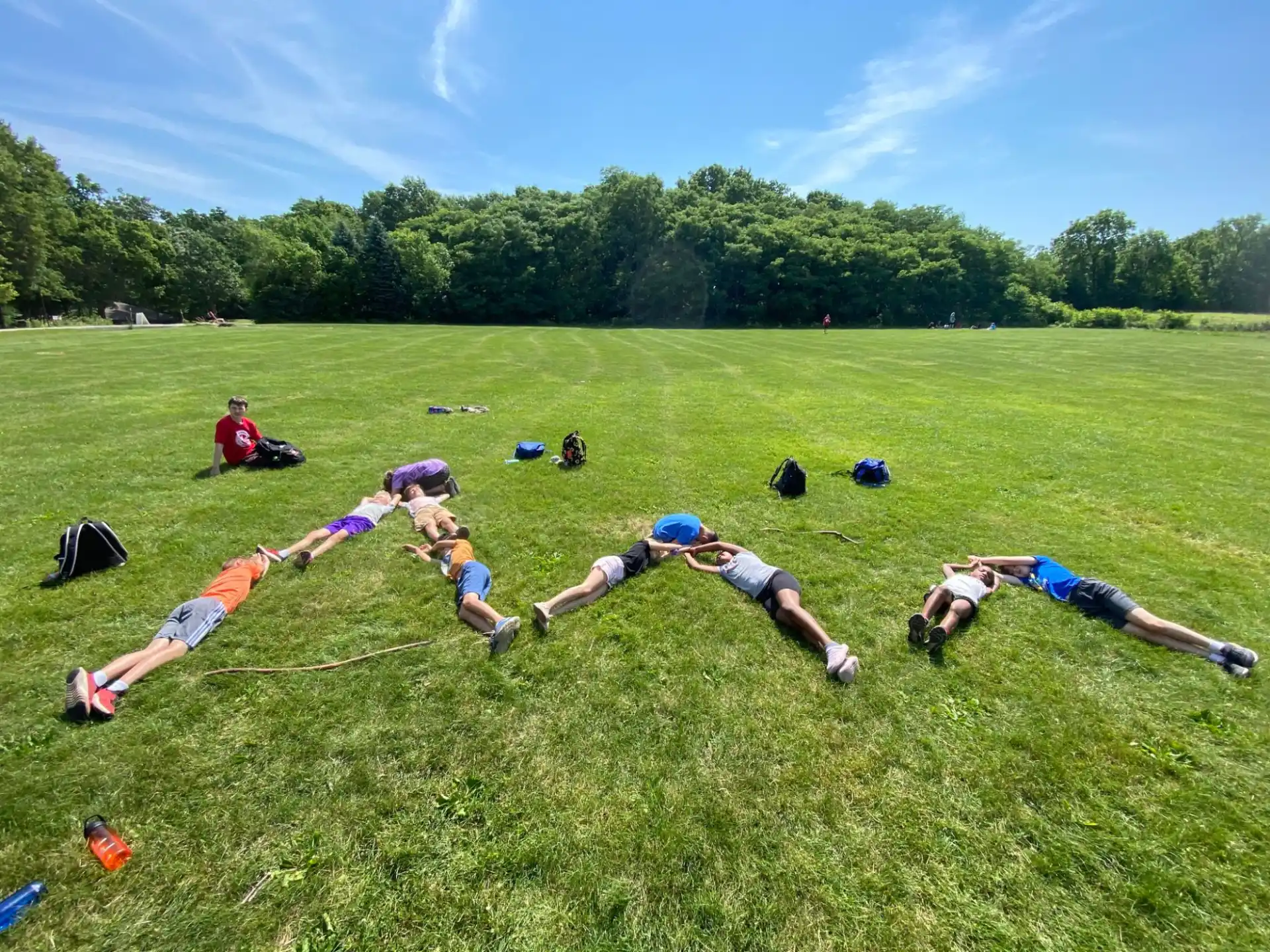 a group of people lying on the grass