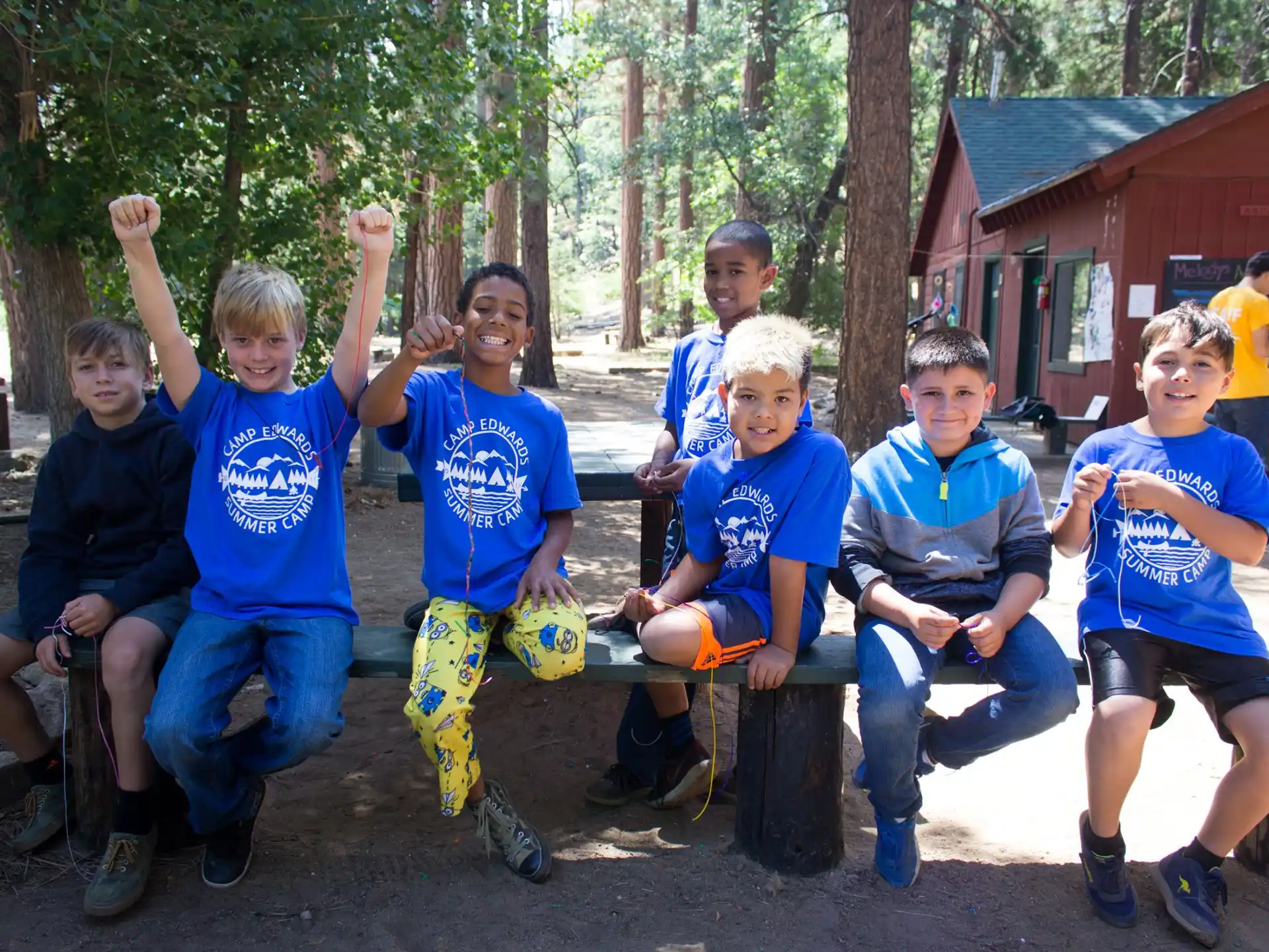 a group of boys sitting on a bench