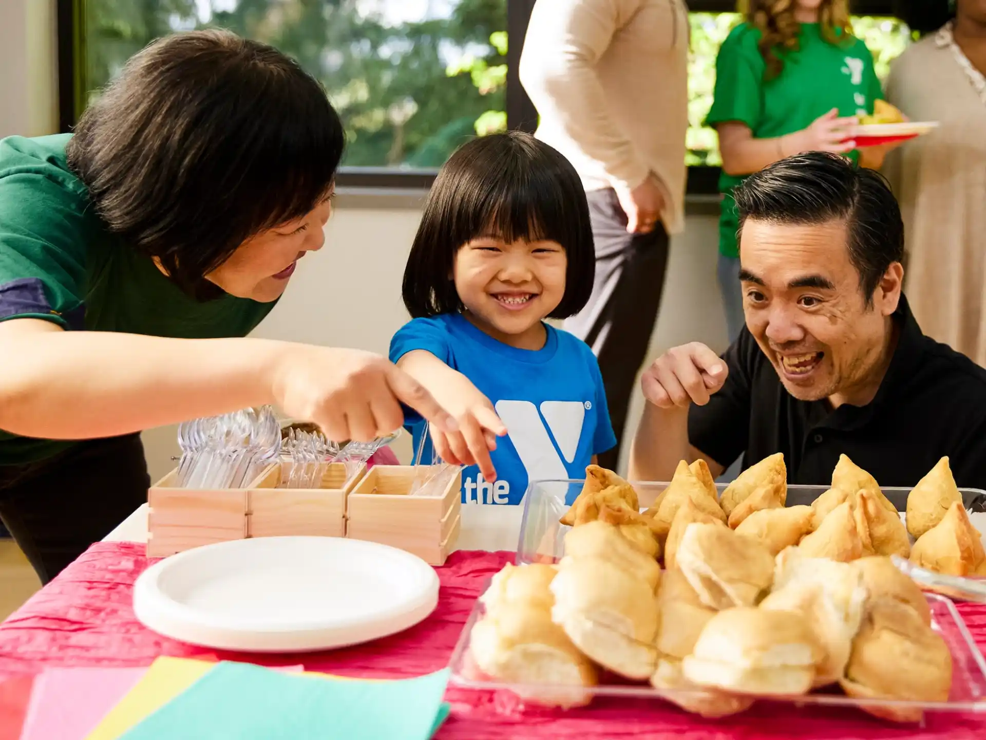 a person and a child eating at a table