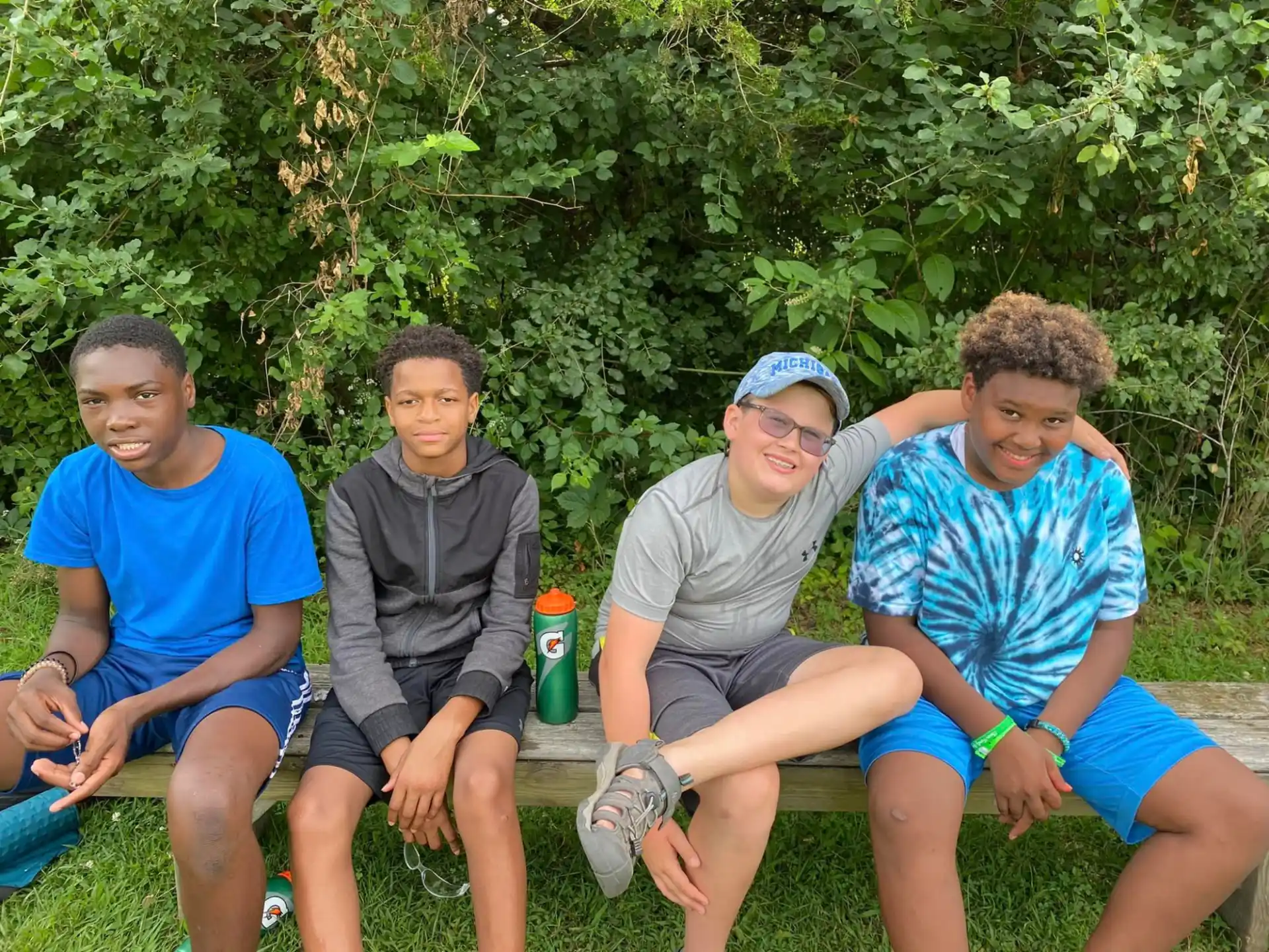 a group of boys sitting on a bench