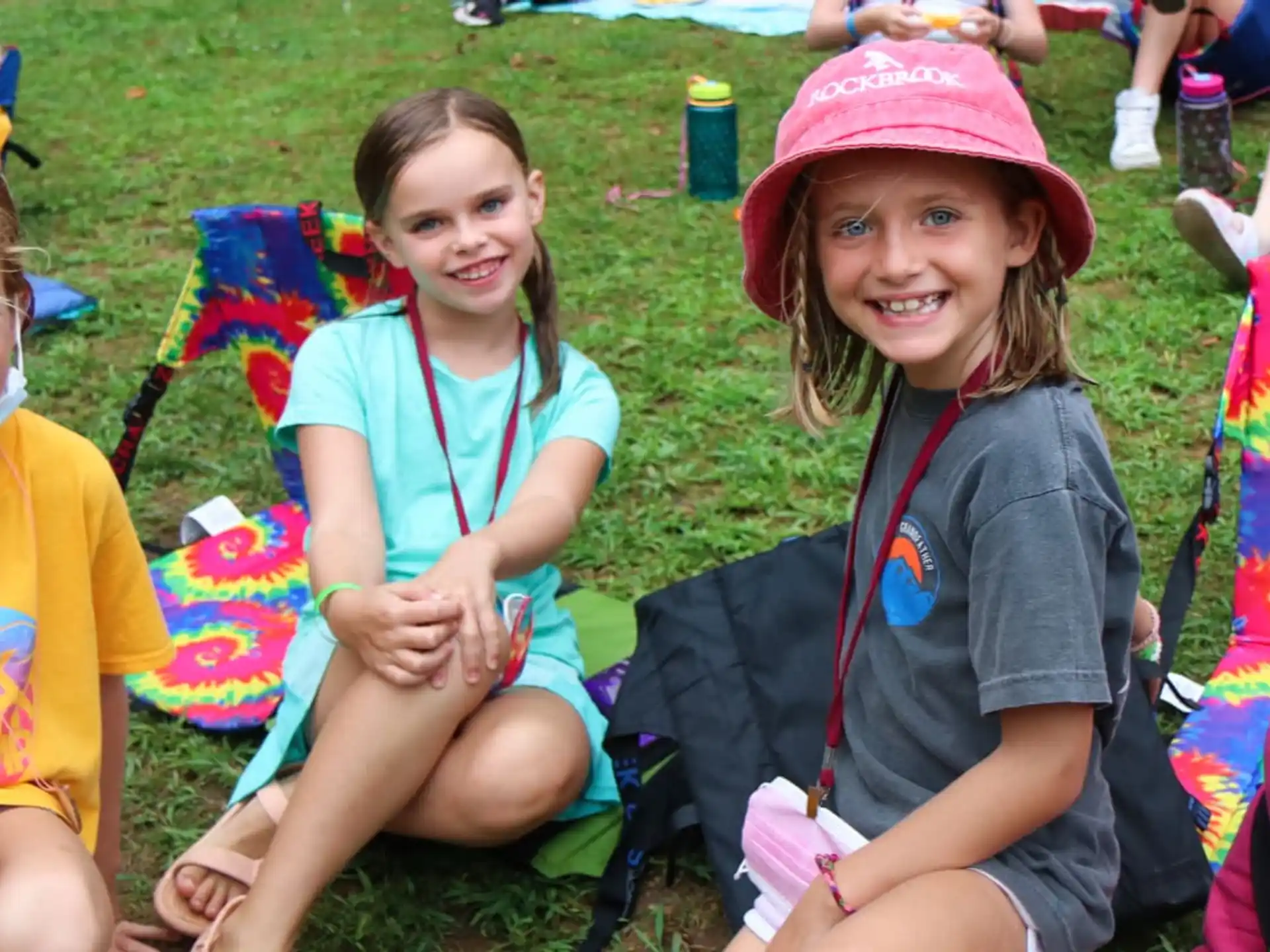 a group of children sitting on the grass