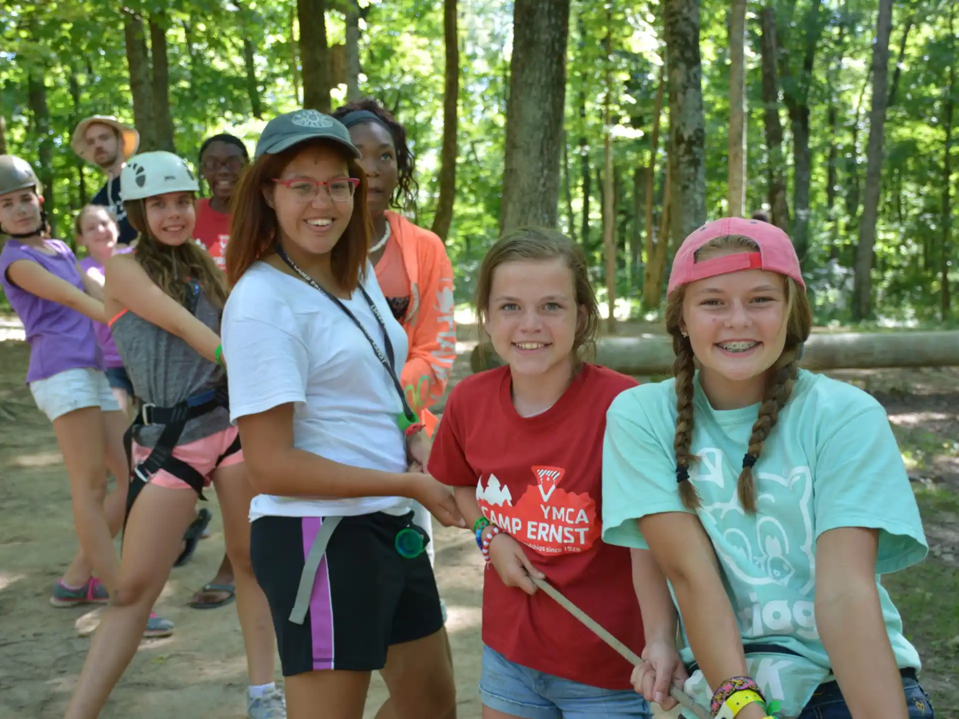 a group of people posing for a photo in the woods