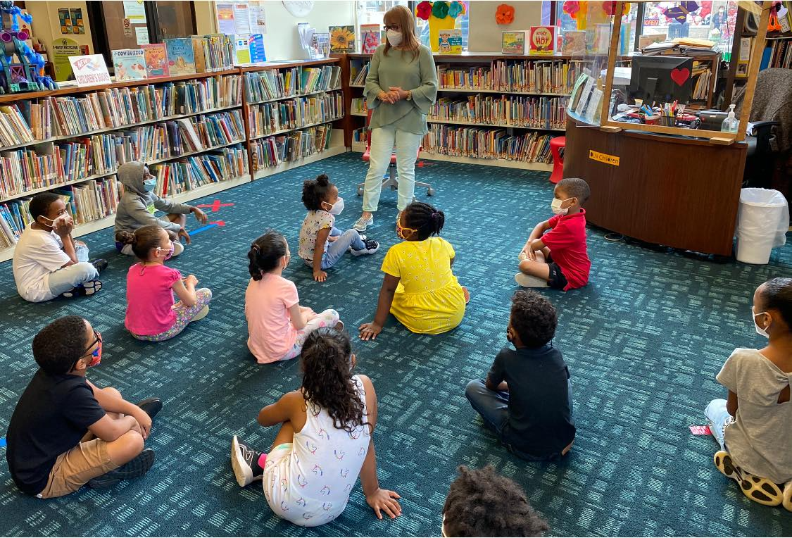 a group of children sitting in a library