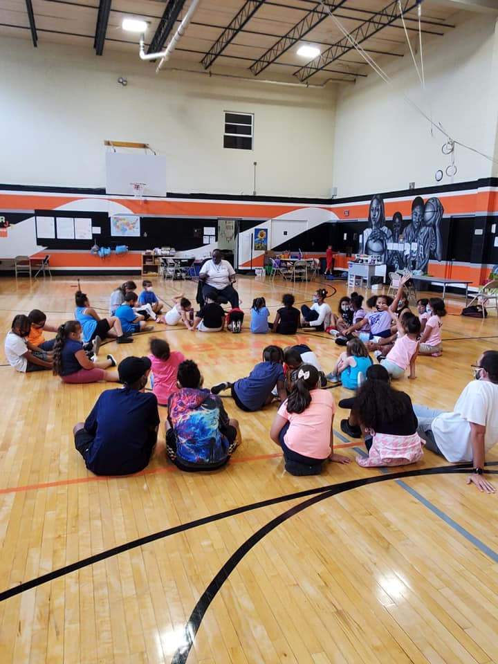 a group of people sitting on the floor in a room