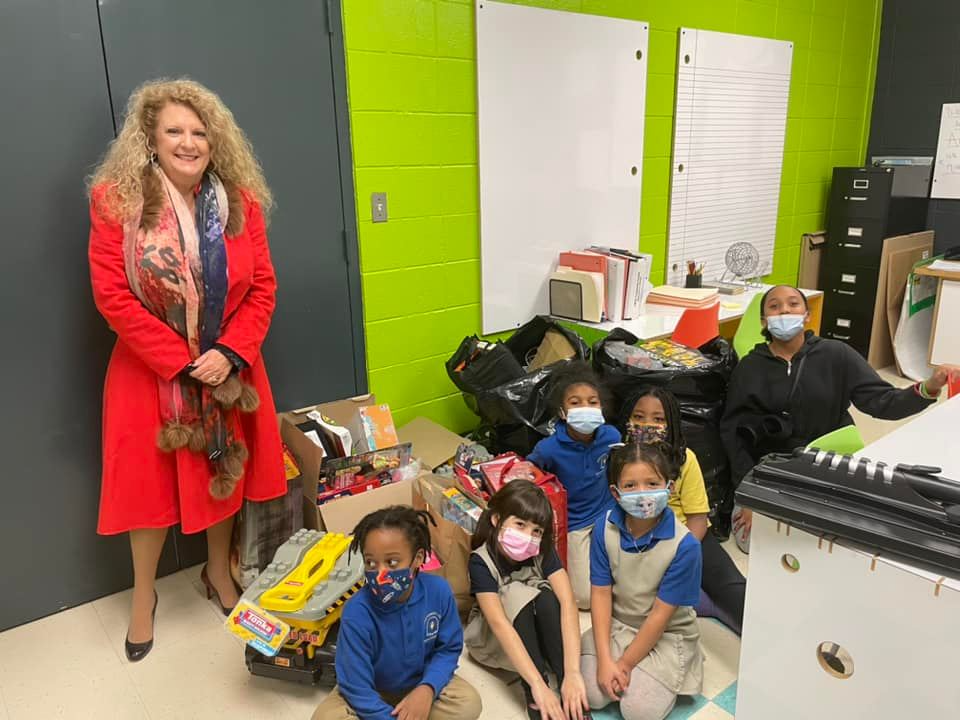 a woman and a group of children wearing masks