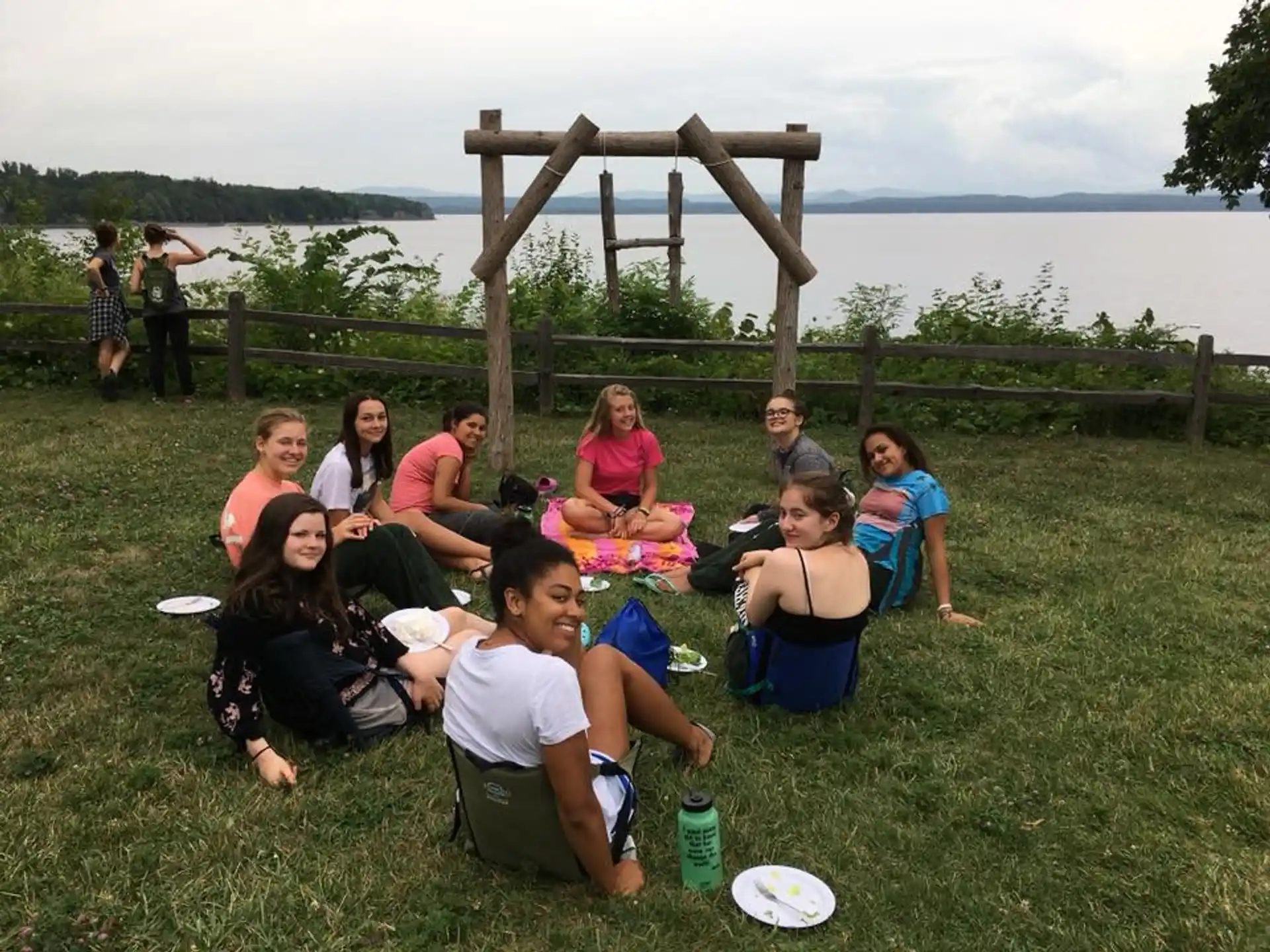 a group of people sitting on the grass