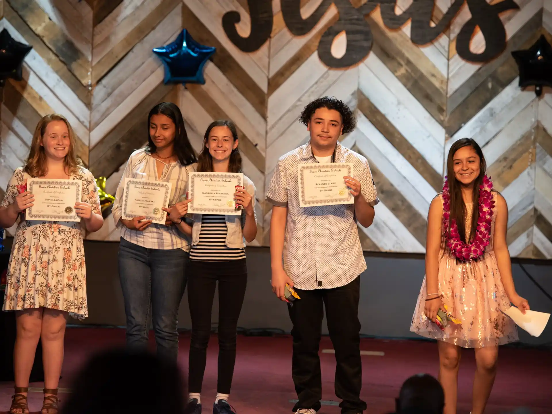 a group of people holding certificates