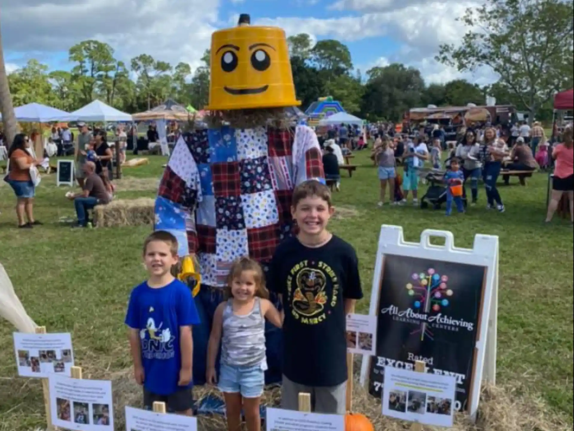 a group of children posing with a person in a garment