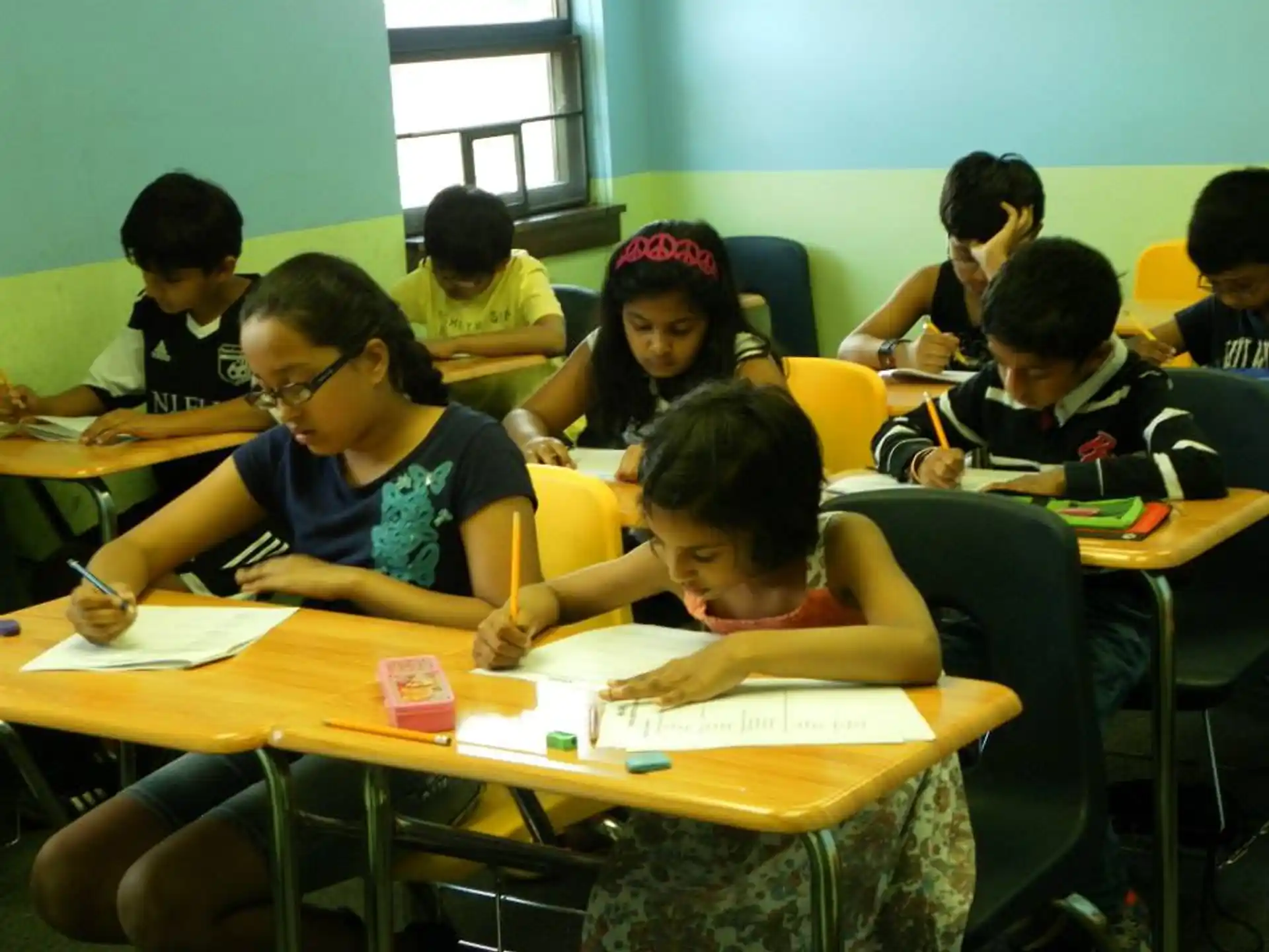 a group of children sitting at desks in a classroom