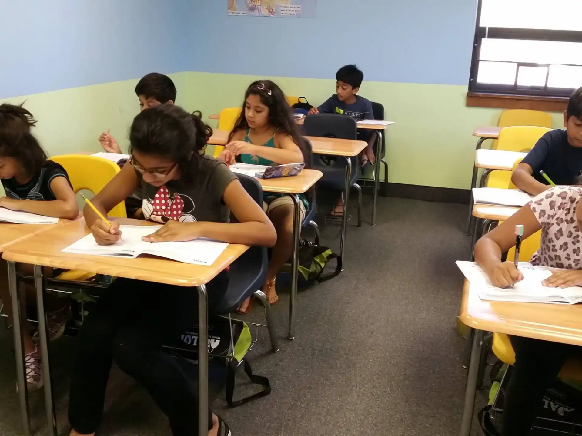a group of children sitting at desks in a classroom