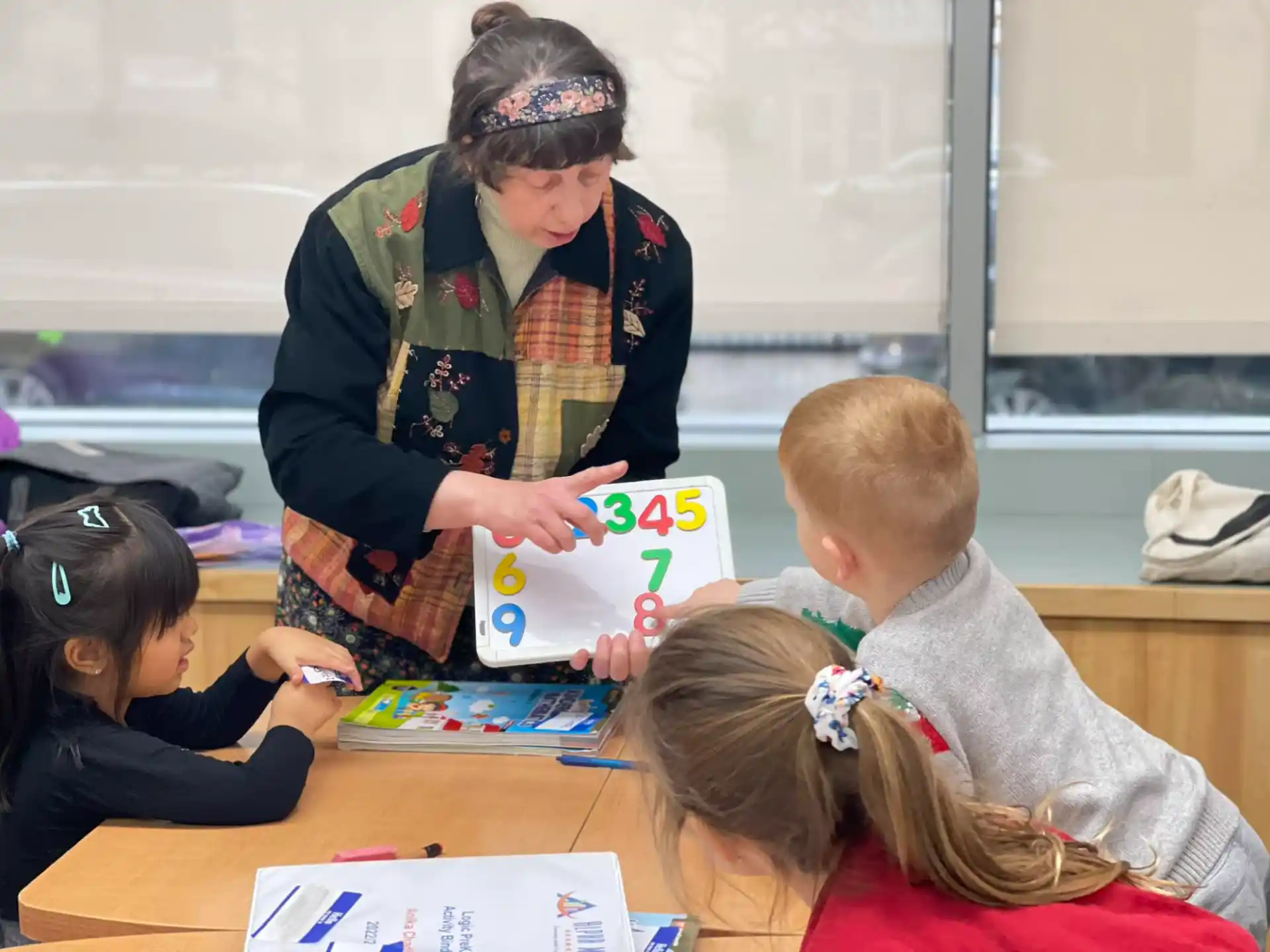 a person handing a box to children