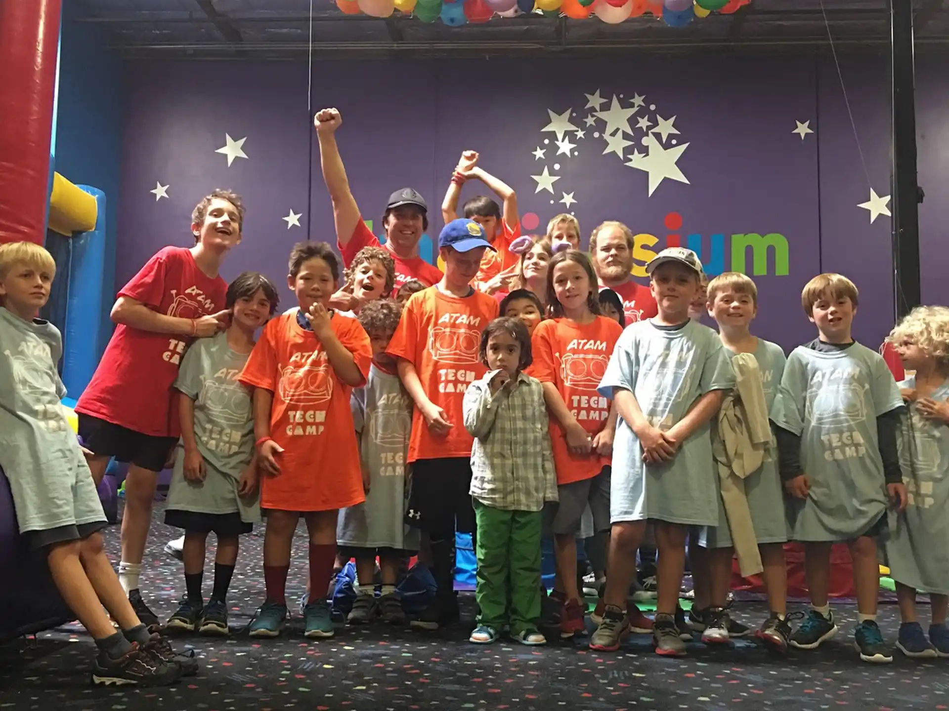 a group of children holding balloons