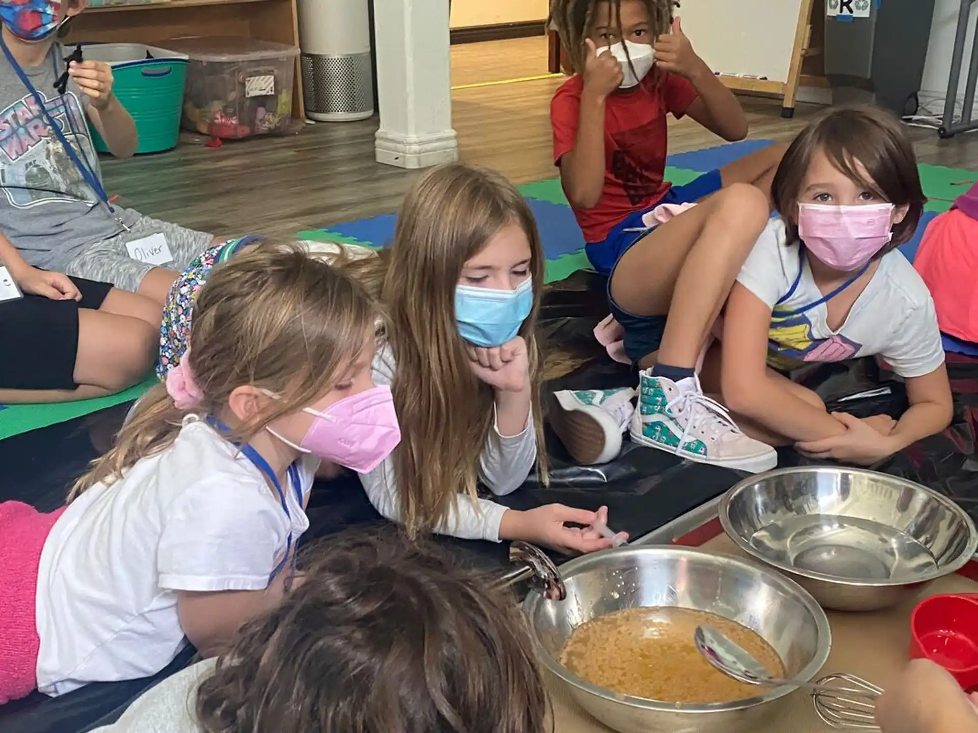 a group of children wearing face masks