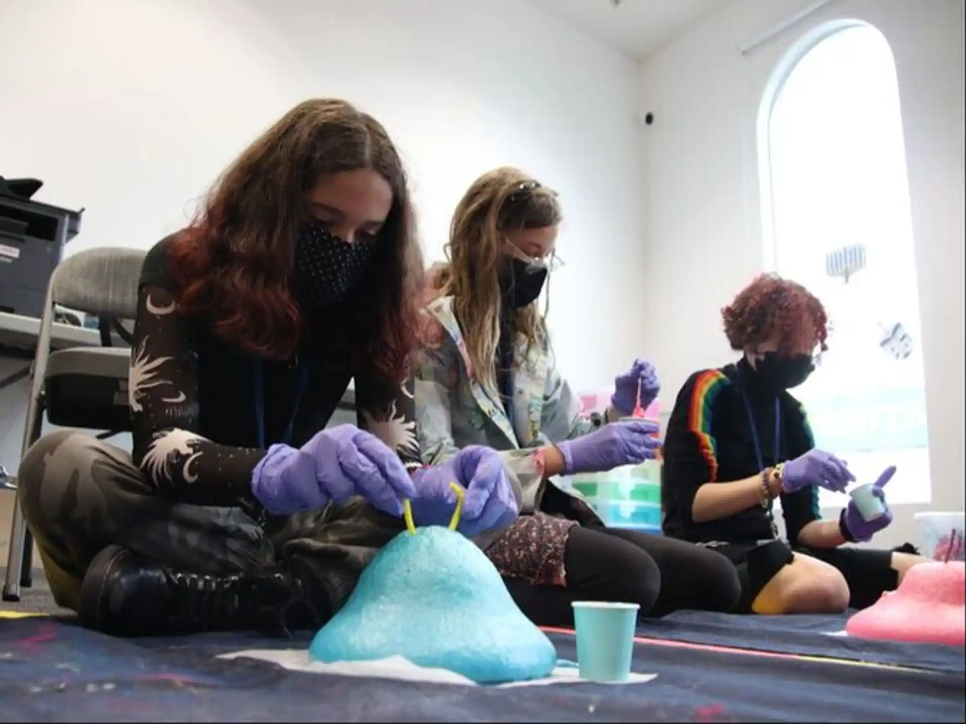a group of women sitting on the floor