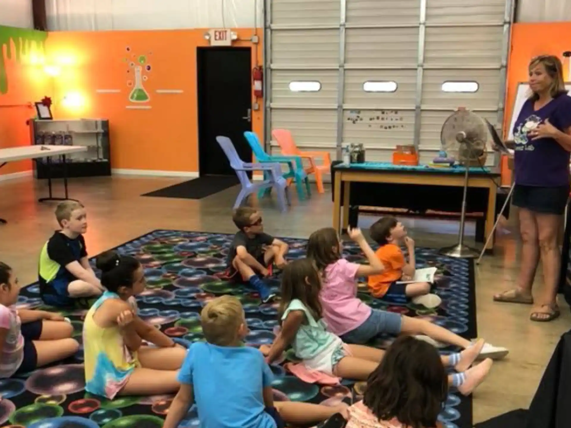 a person teaching a group of children