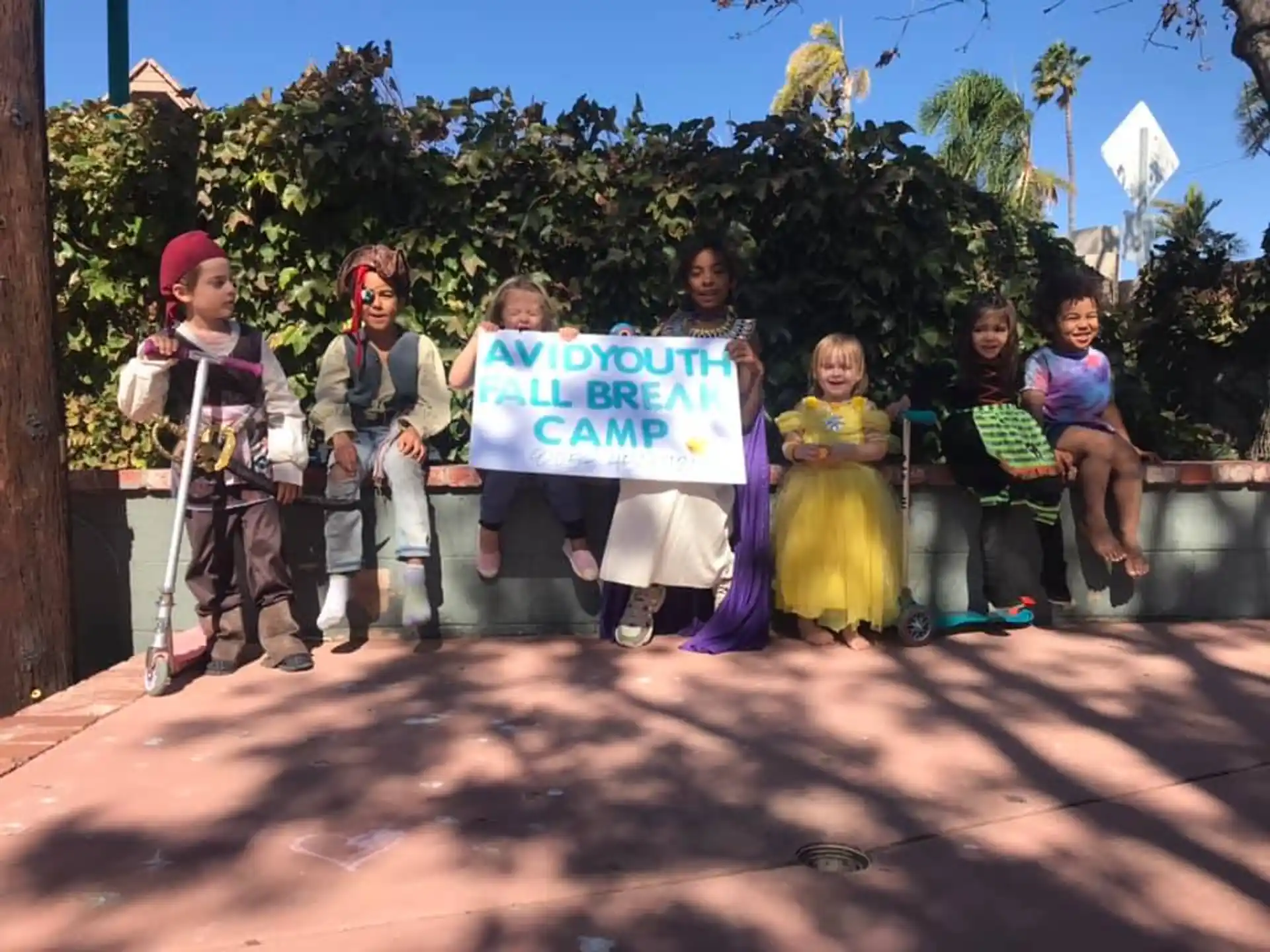 a group of children holding a sign