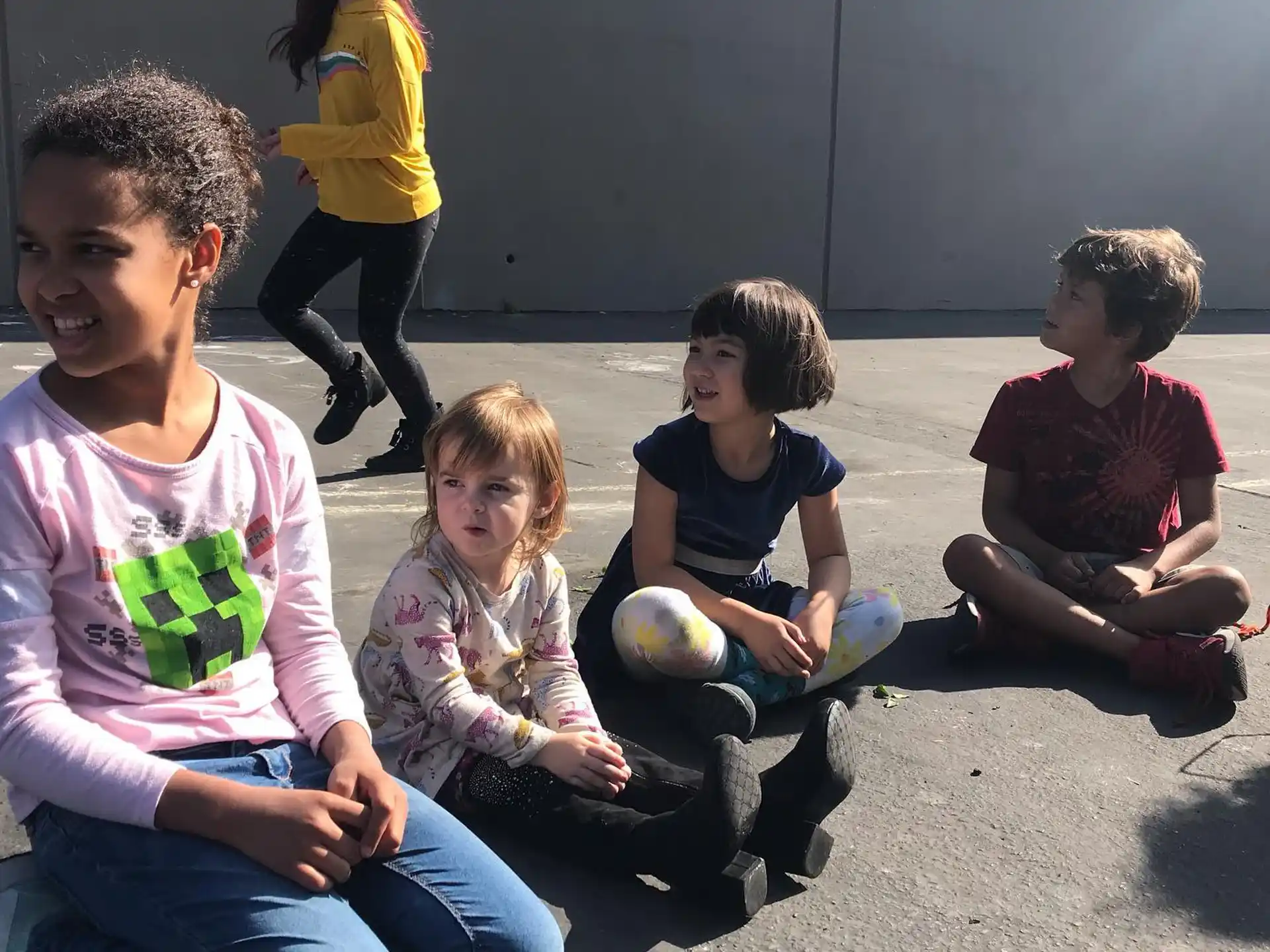 a group of children sitting on the ground