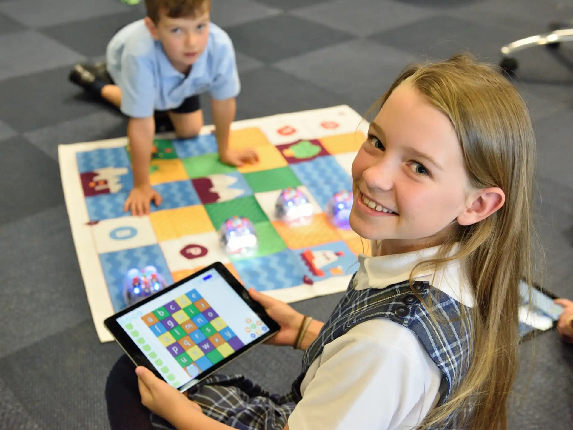 a girl and a boy playing a board game