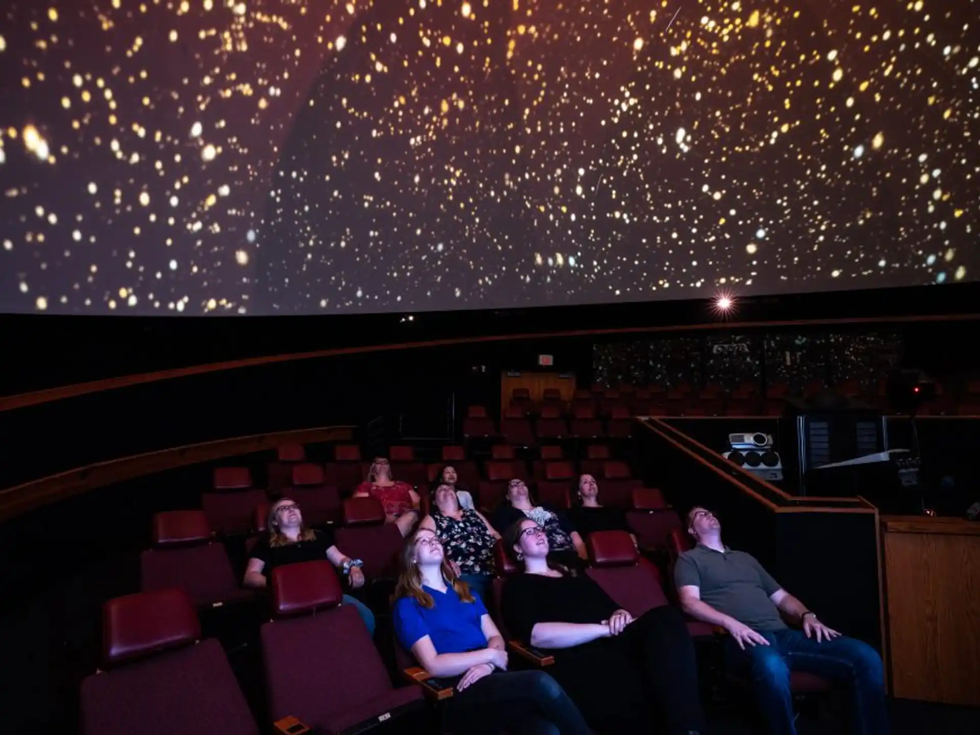 a group of people sitting in a theater