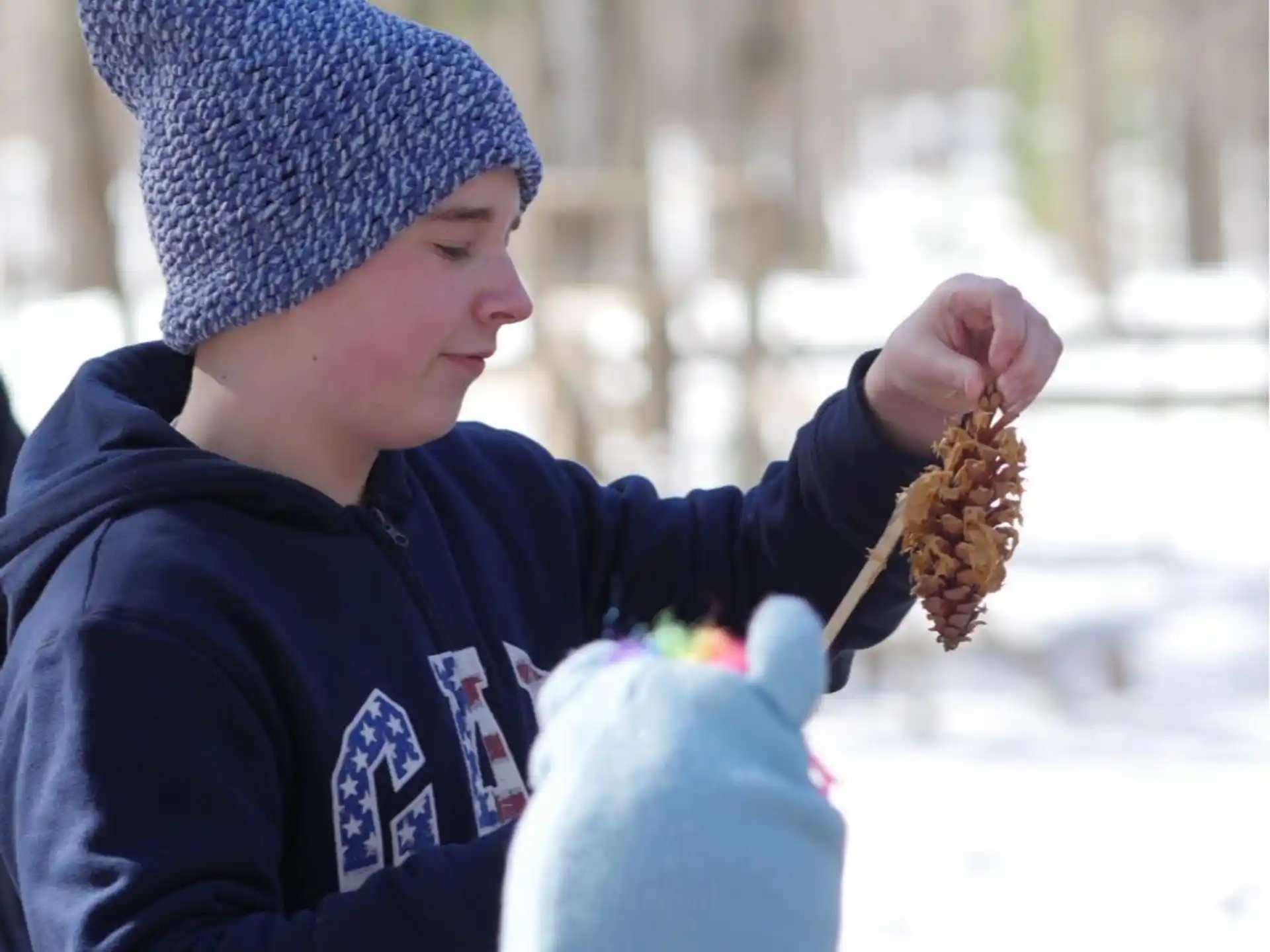 a person holding a pinecone