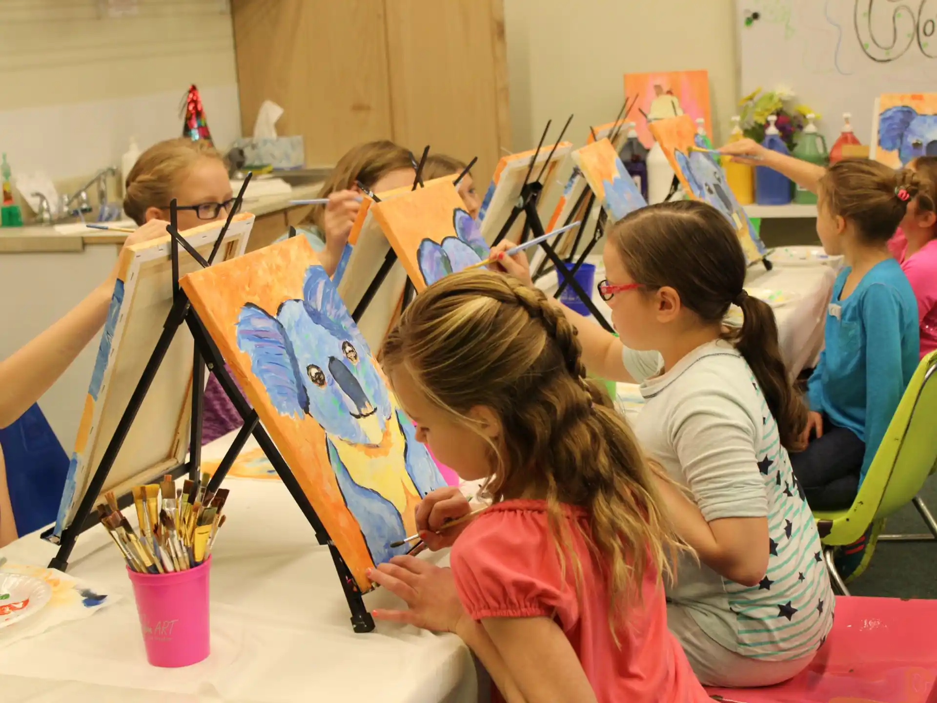 a group of children painting