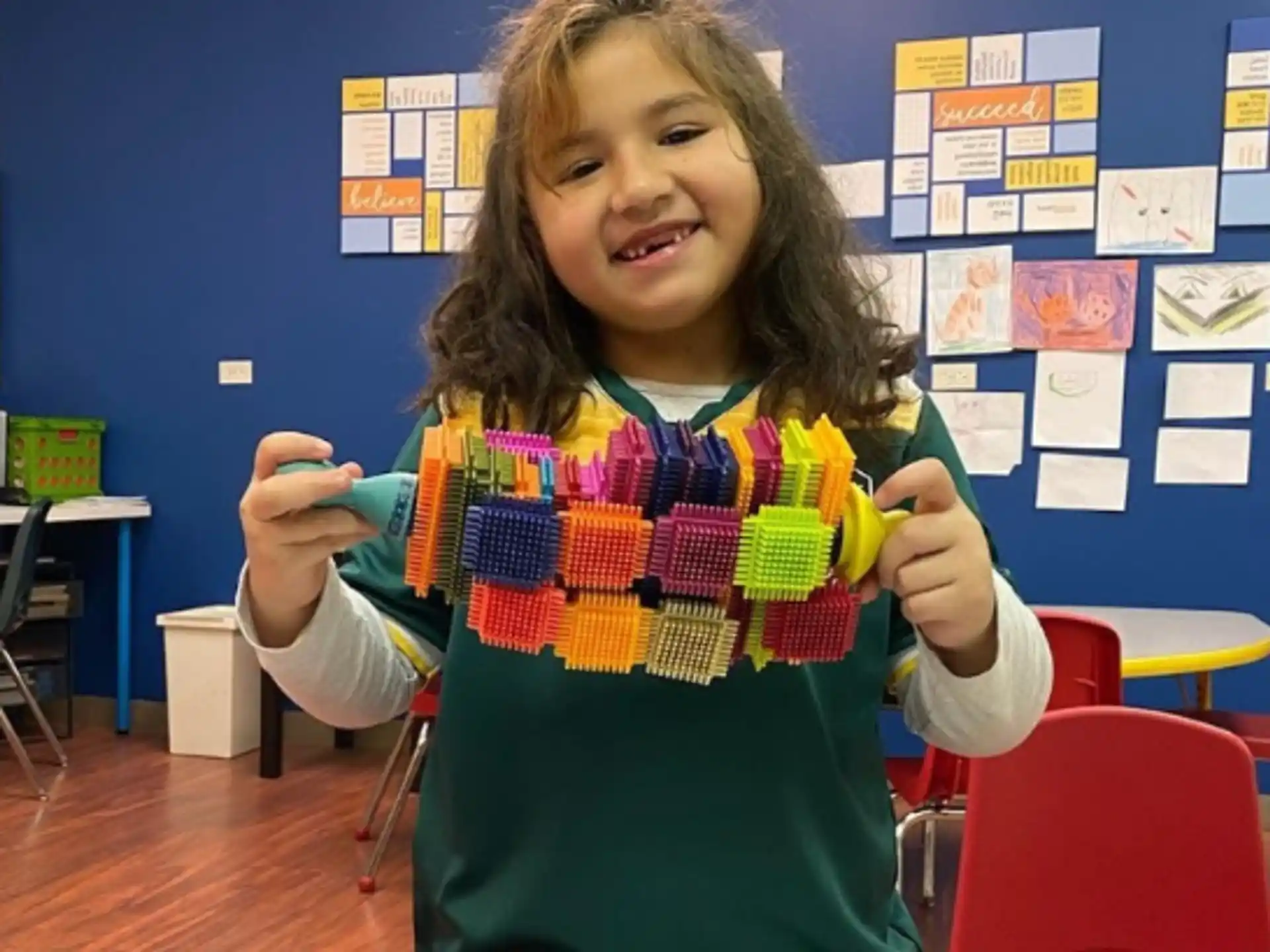 a girl holding a toy