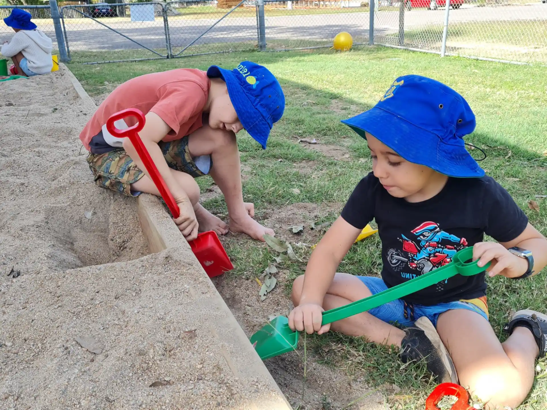 a couple of kids playing in the sand