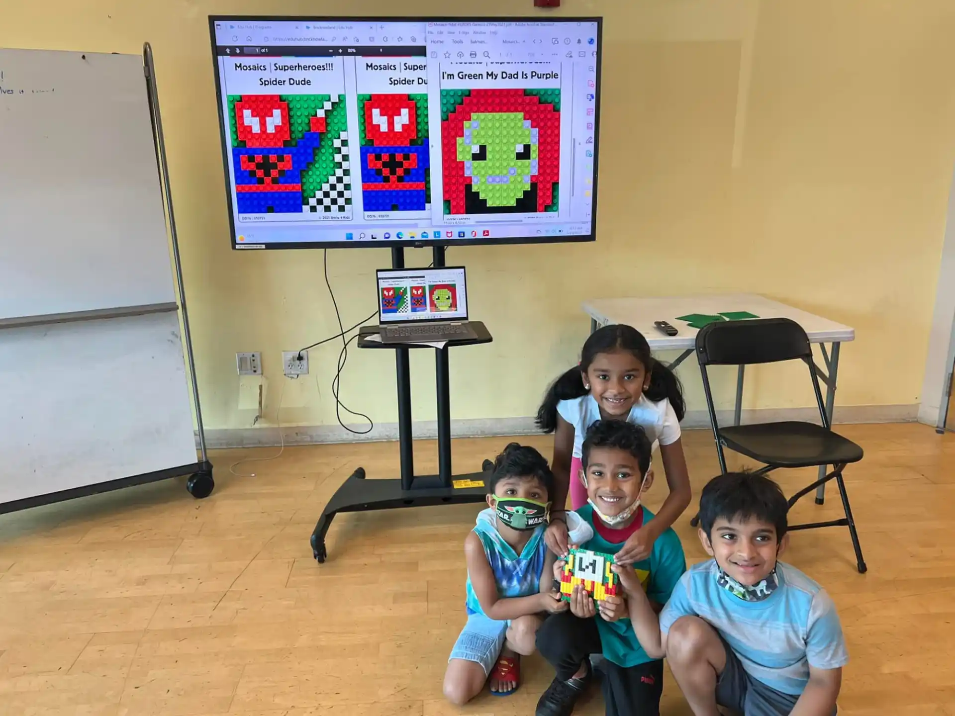 a group of kids sitting in front of a tv