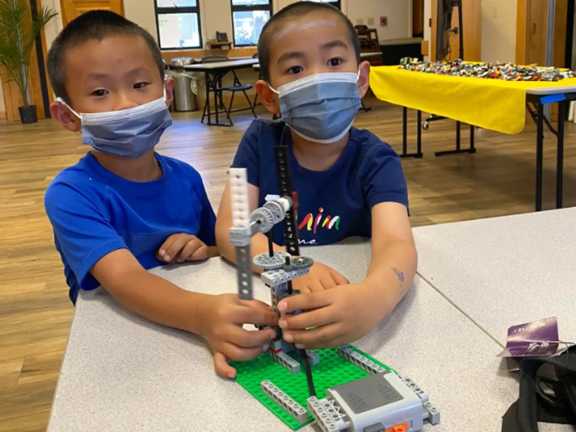 two boys playing with a toy