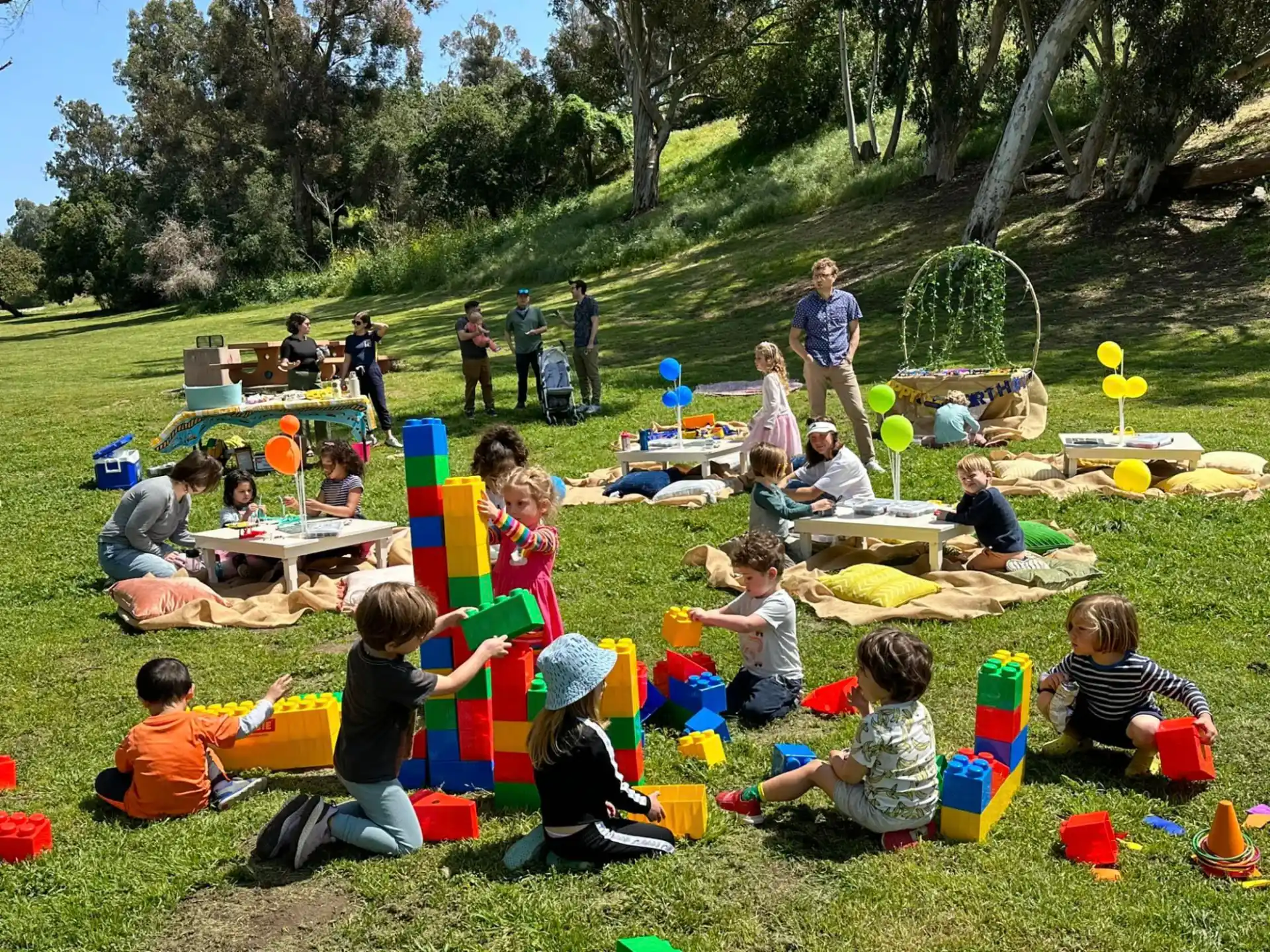 a group of people sitting on the grass
