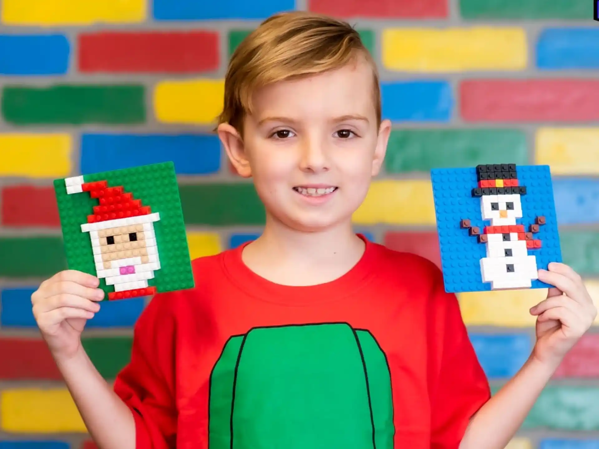 a boy holding up a few colorful boxes
