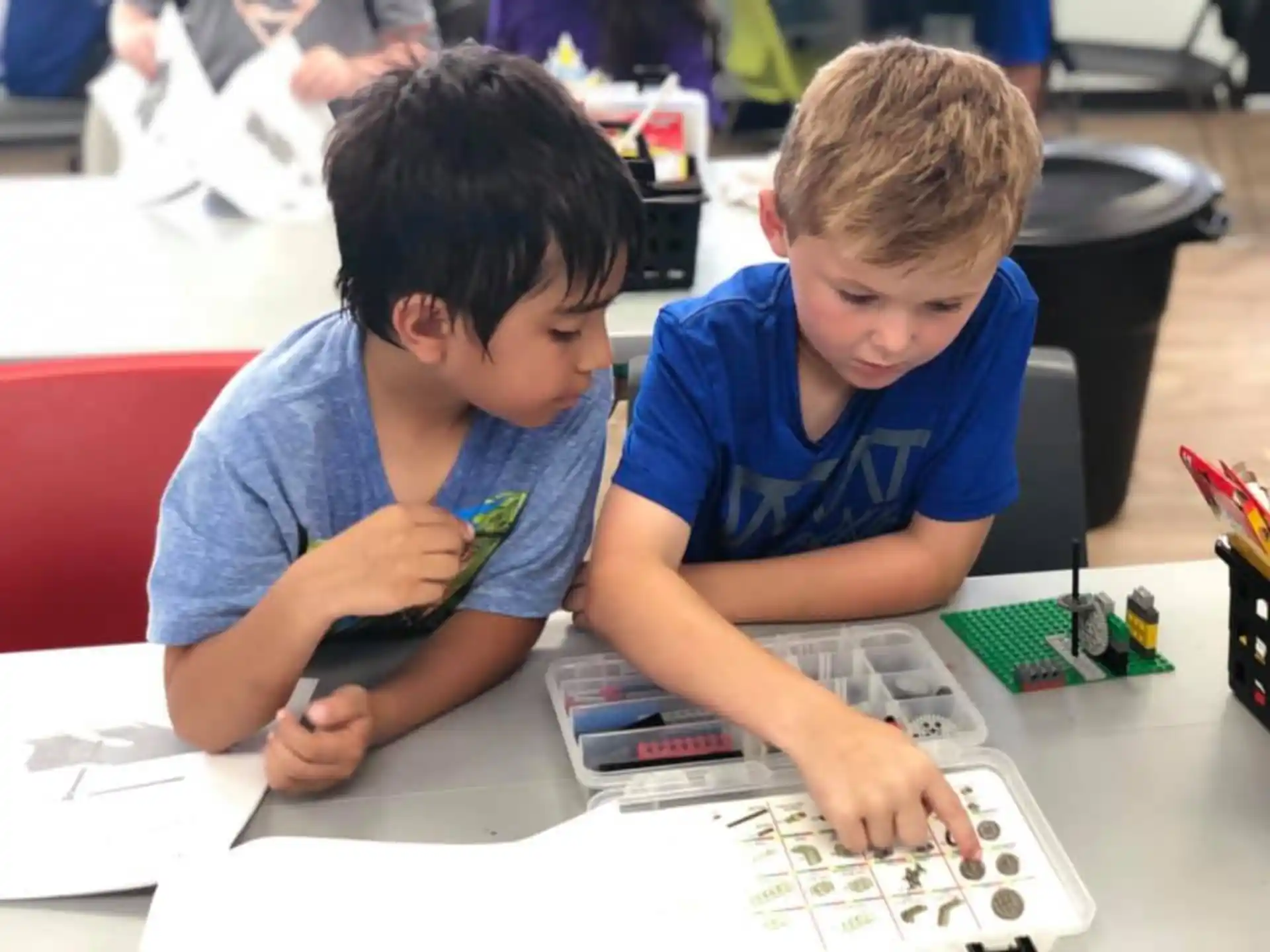 a few young boys working on a computer