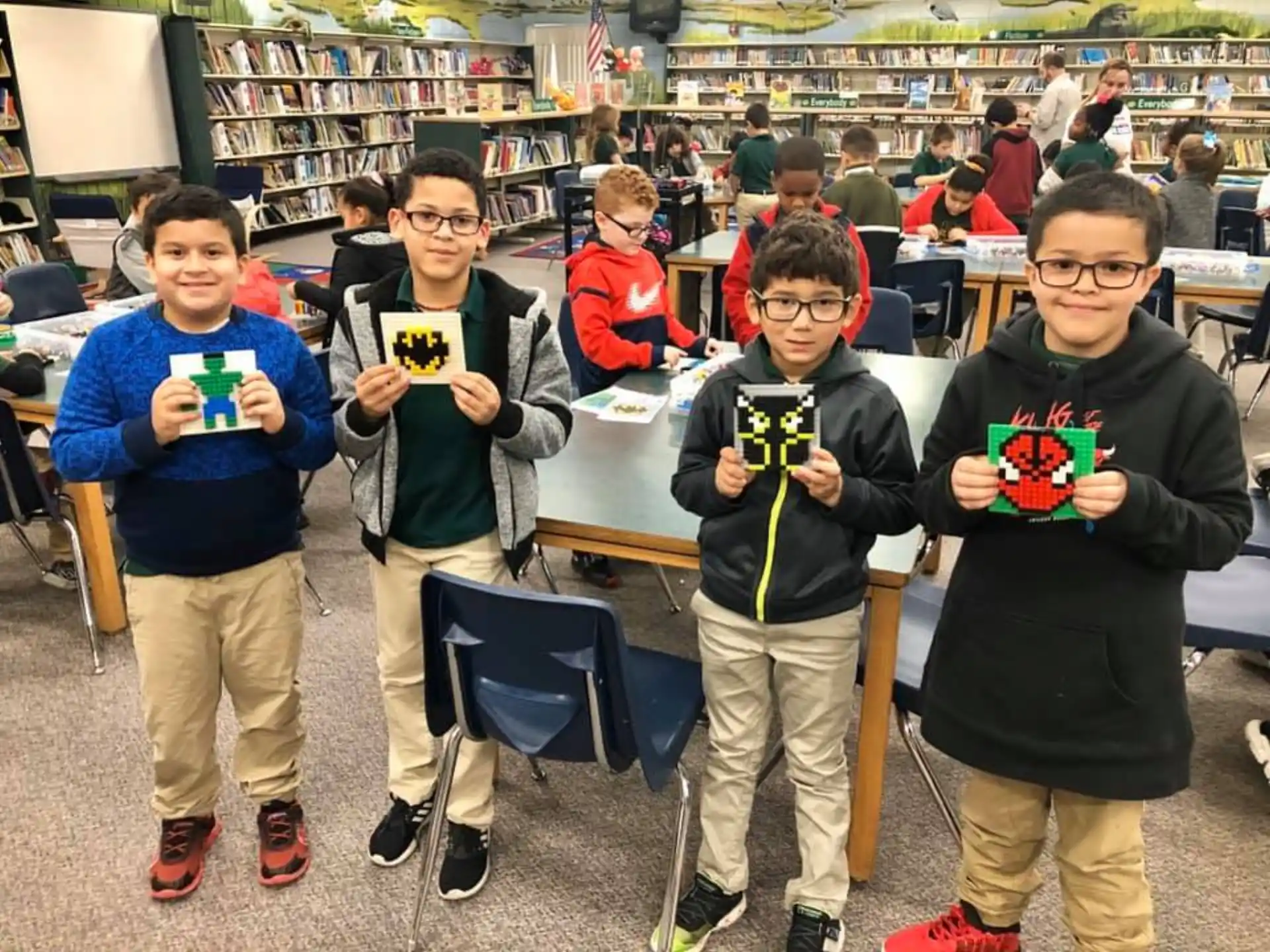 a group of boys holding objects posing for the camera
