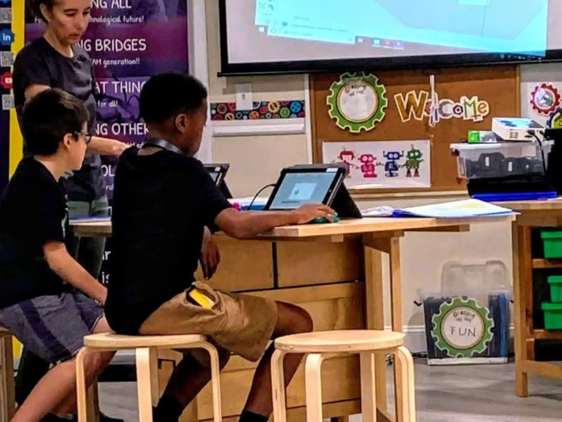 a group of people sitting at a desk with a laptop