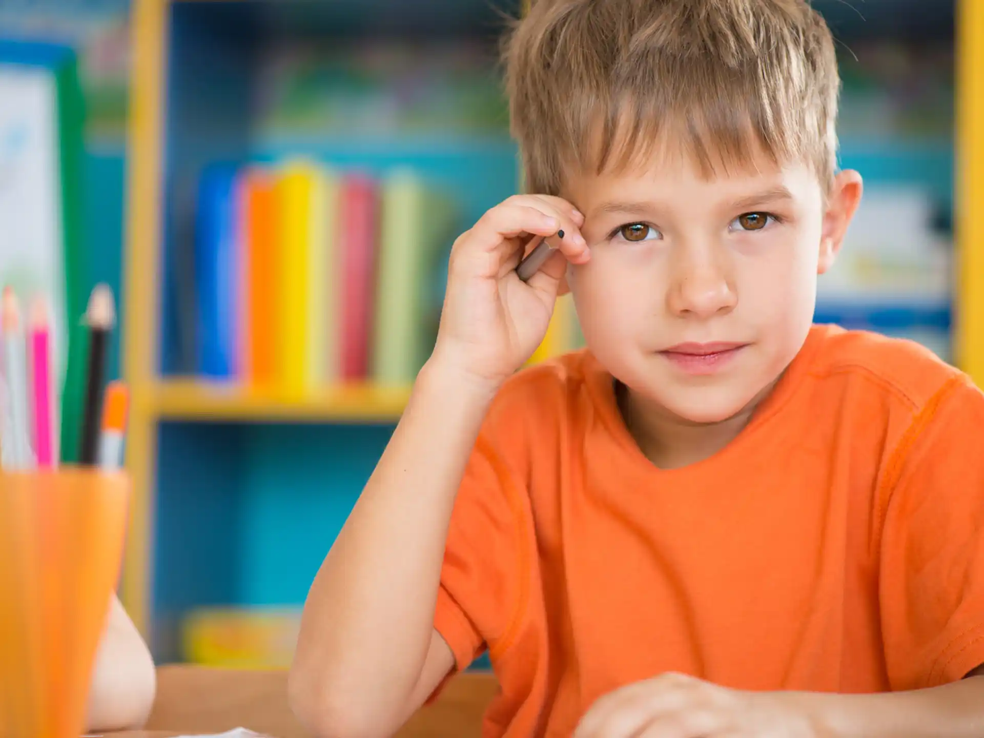 a boy sitting at a desk